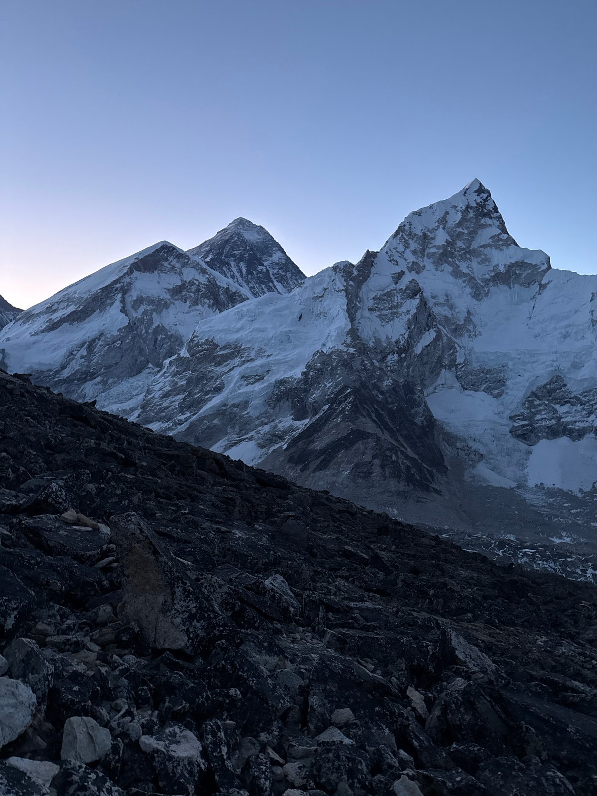 Hikers trek rocky Himalayan paths near Khumjung at dawn