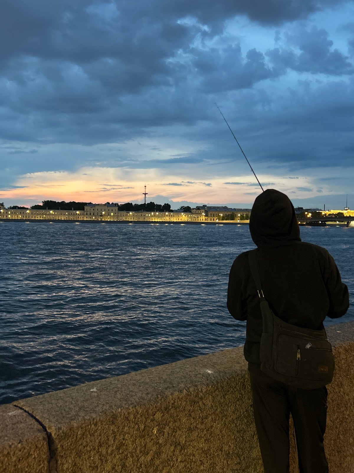 Evening fishing and cycling activity observed along St. Petersburg riverfront