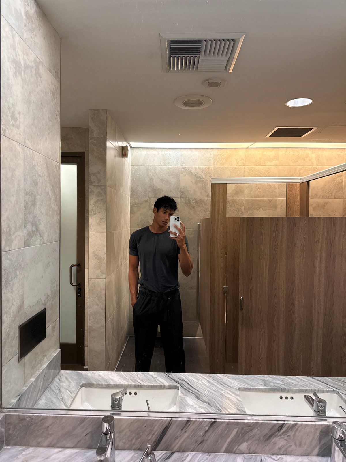 Man takes bathroom mirror selfie in Los Angeles