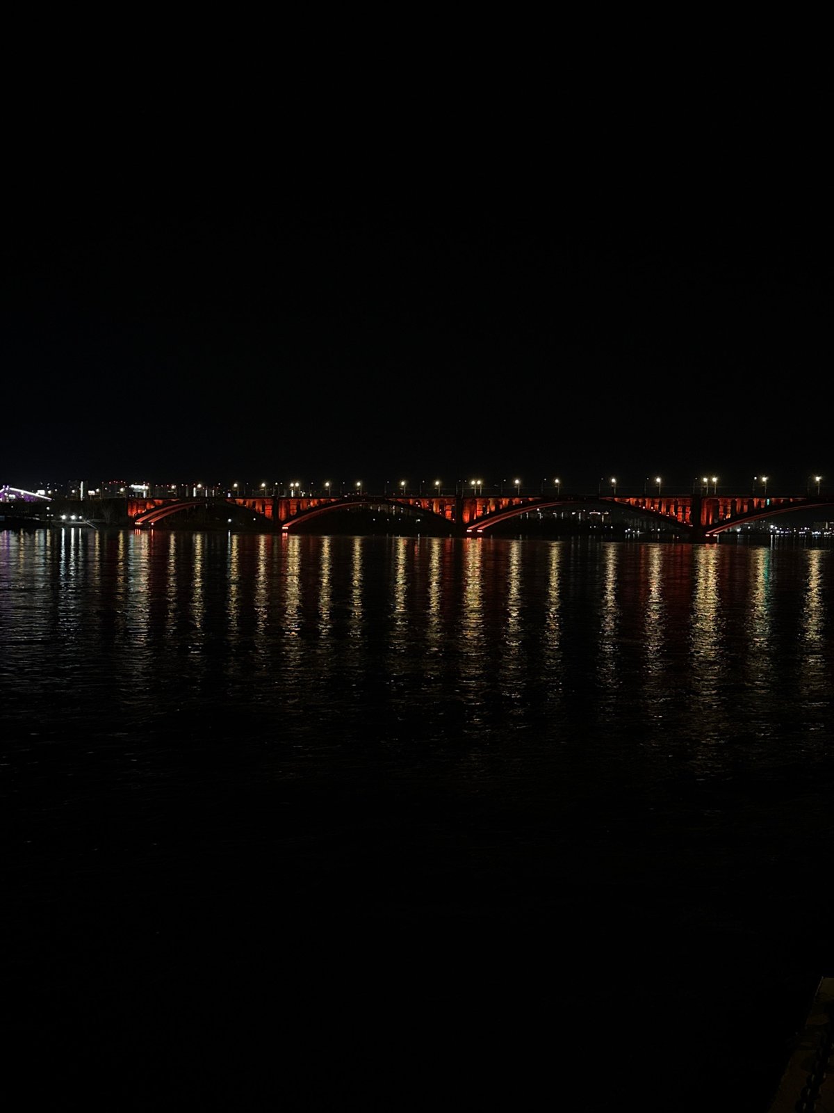Red bridge photographed at night in Krasnoyarsk, Russia