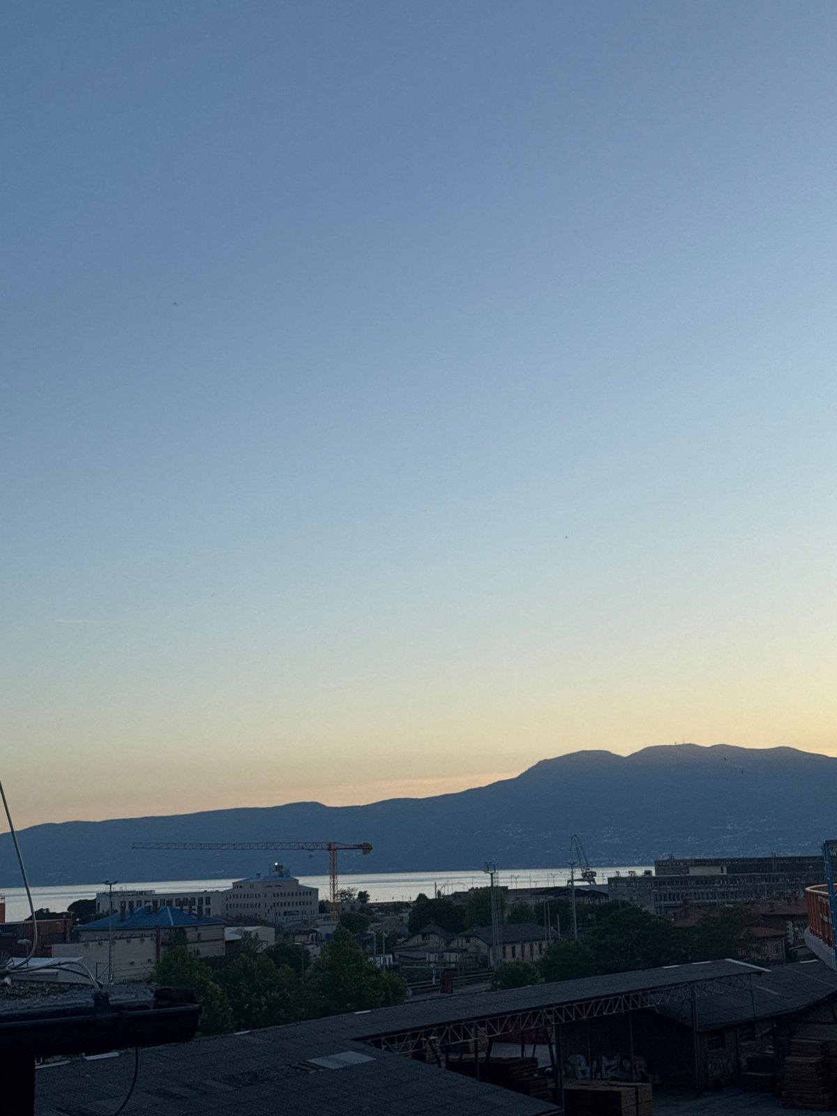 Elevated view of Rijeka cityscape captured under blue skies