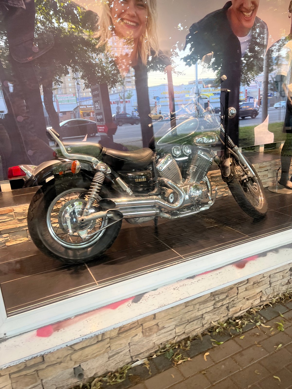 Storefront Yamaha display and sidewalk life in Voronezh