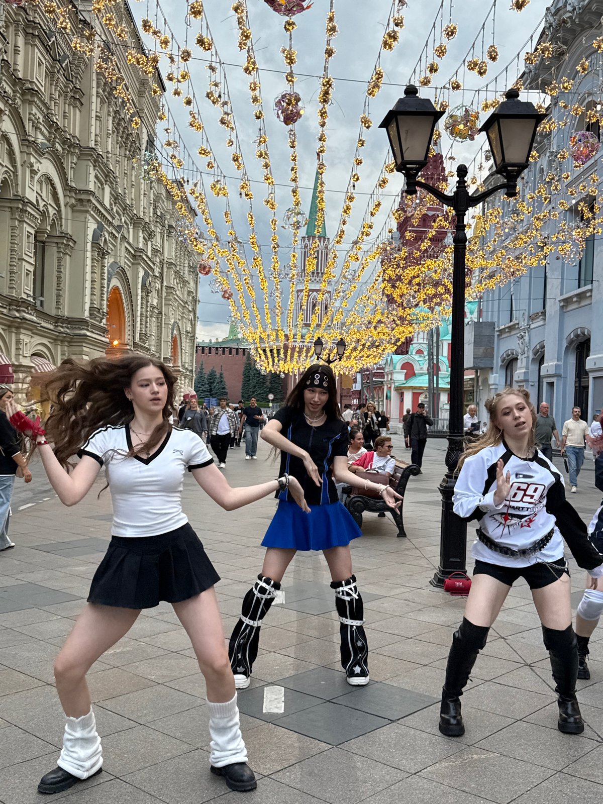 Dancing and posing on a lit pedestrian street