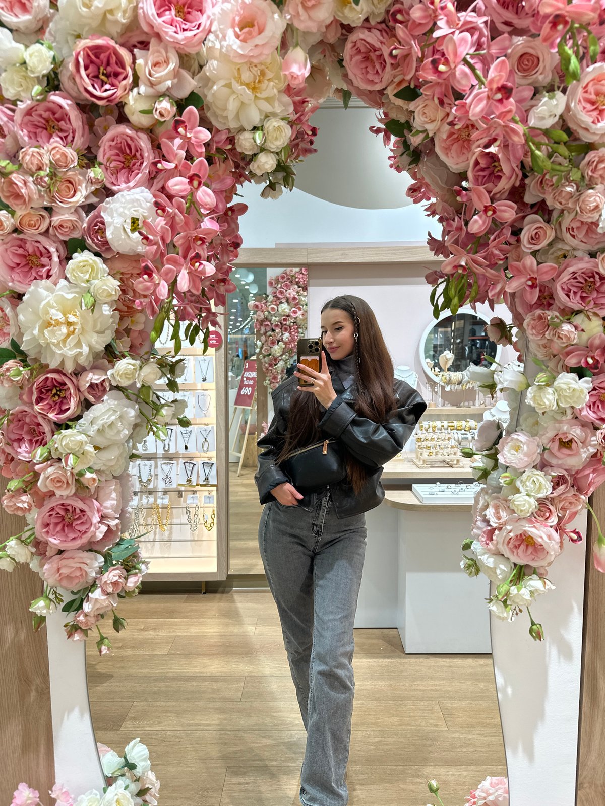 Woman takes selfie in flower-adorned mirror in Yekaterinburg