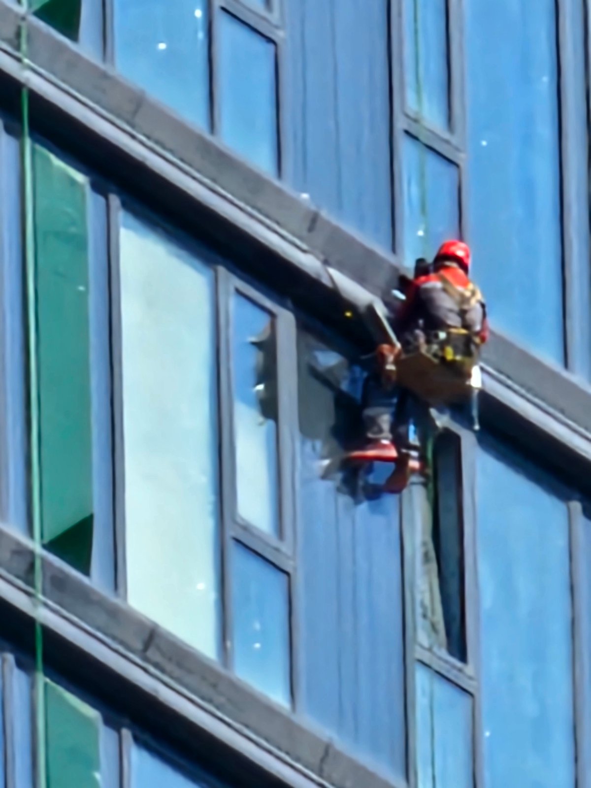 High-rise construction and window work underway on Moscow glass building
