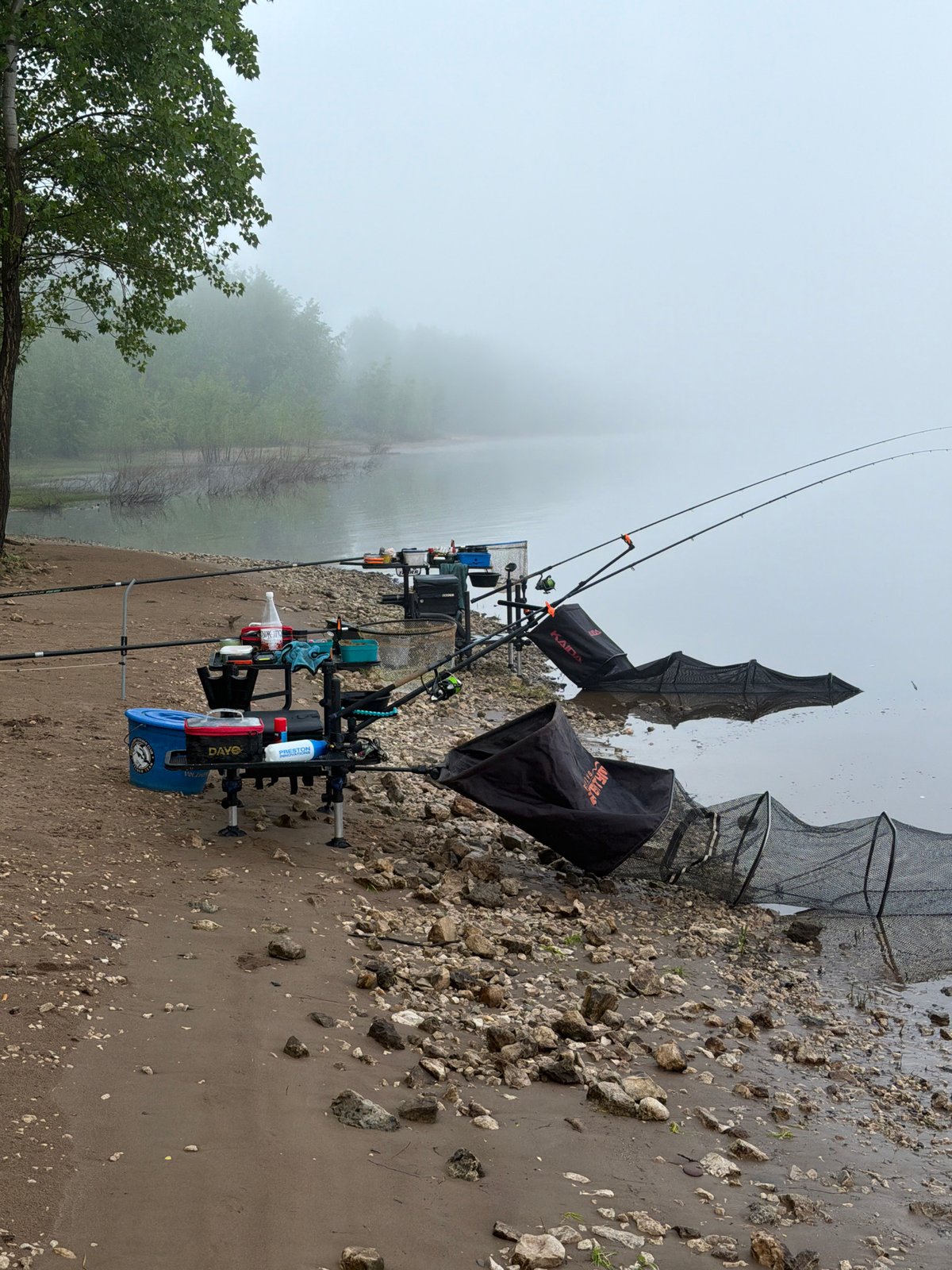 Solitary fishing setup captured on misty riverbank in Noviy