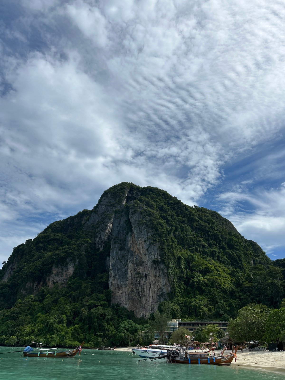 Tourists explore Ao Nang's limestone cliffs and beaches by boat