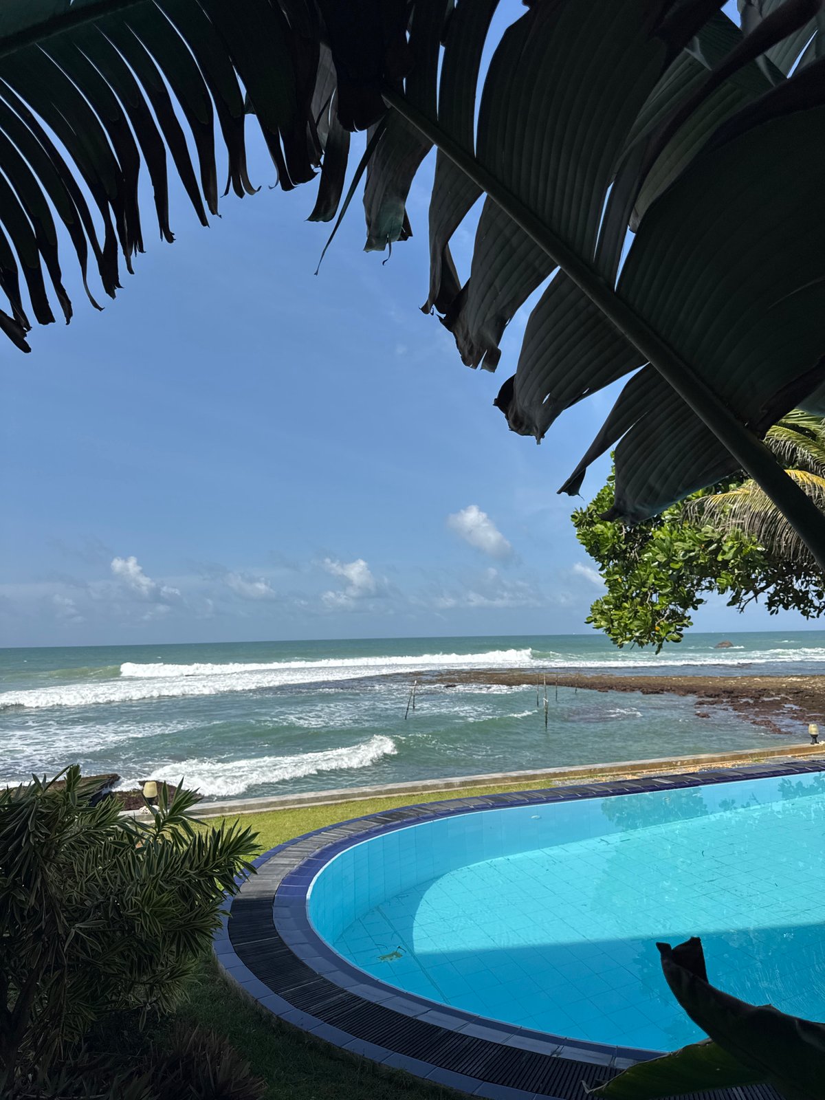 Poolside ocean view at a Sri Lankan coastal resort