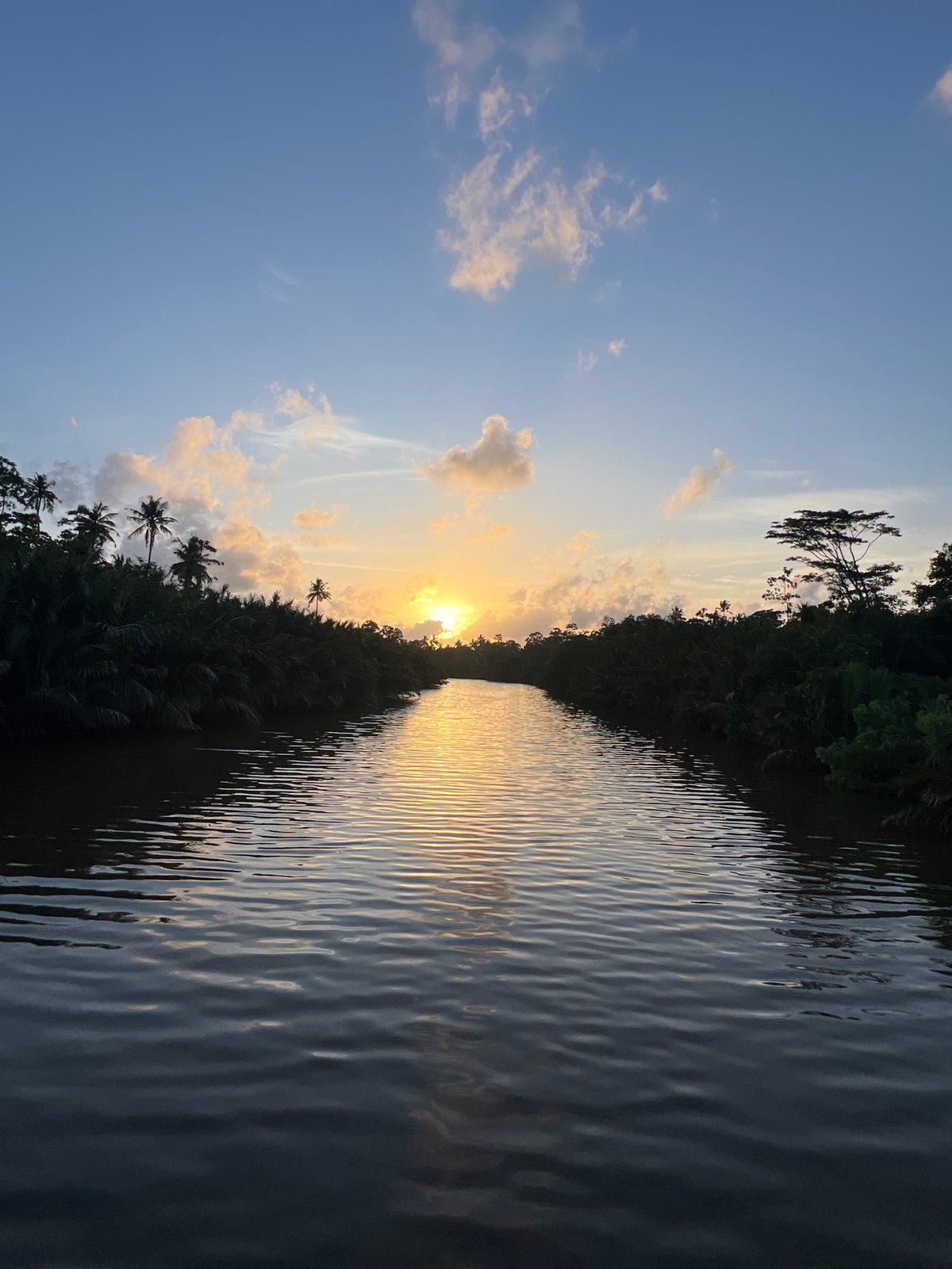 Sunset light plays across a Sri Lankan river at dusk