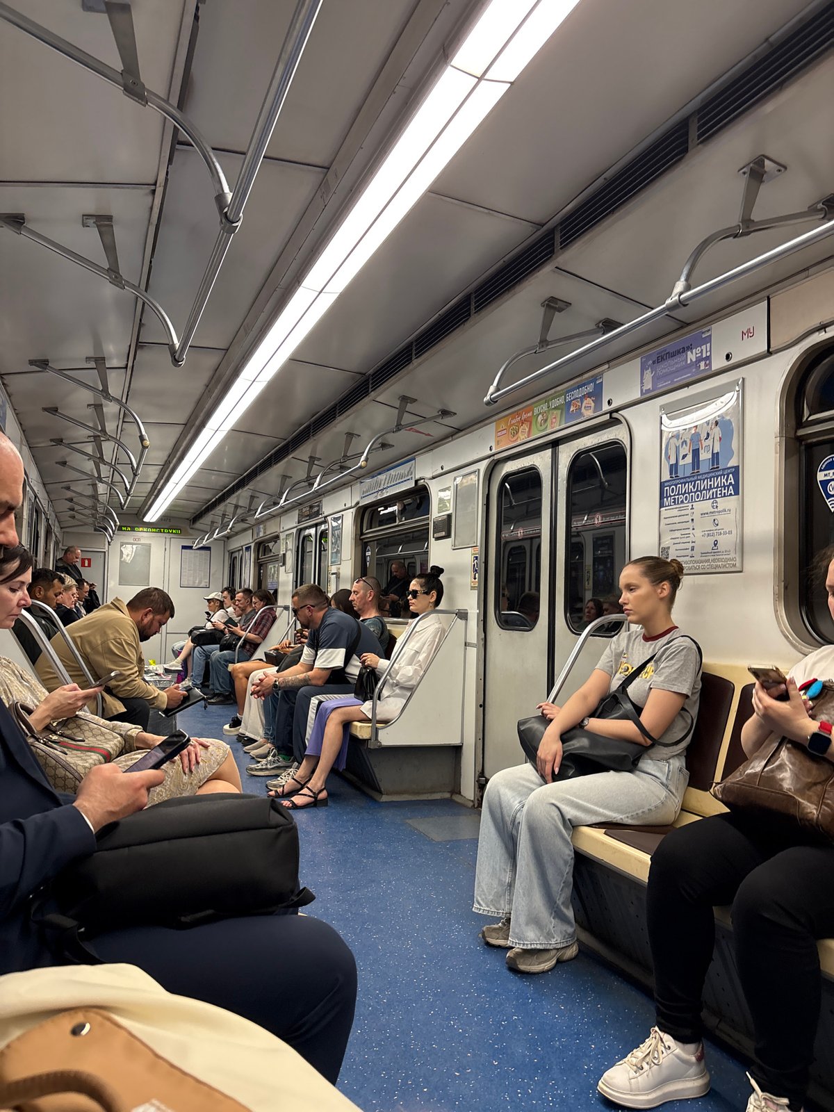 Saint Petersburg subway passengers use phones during transit