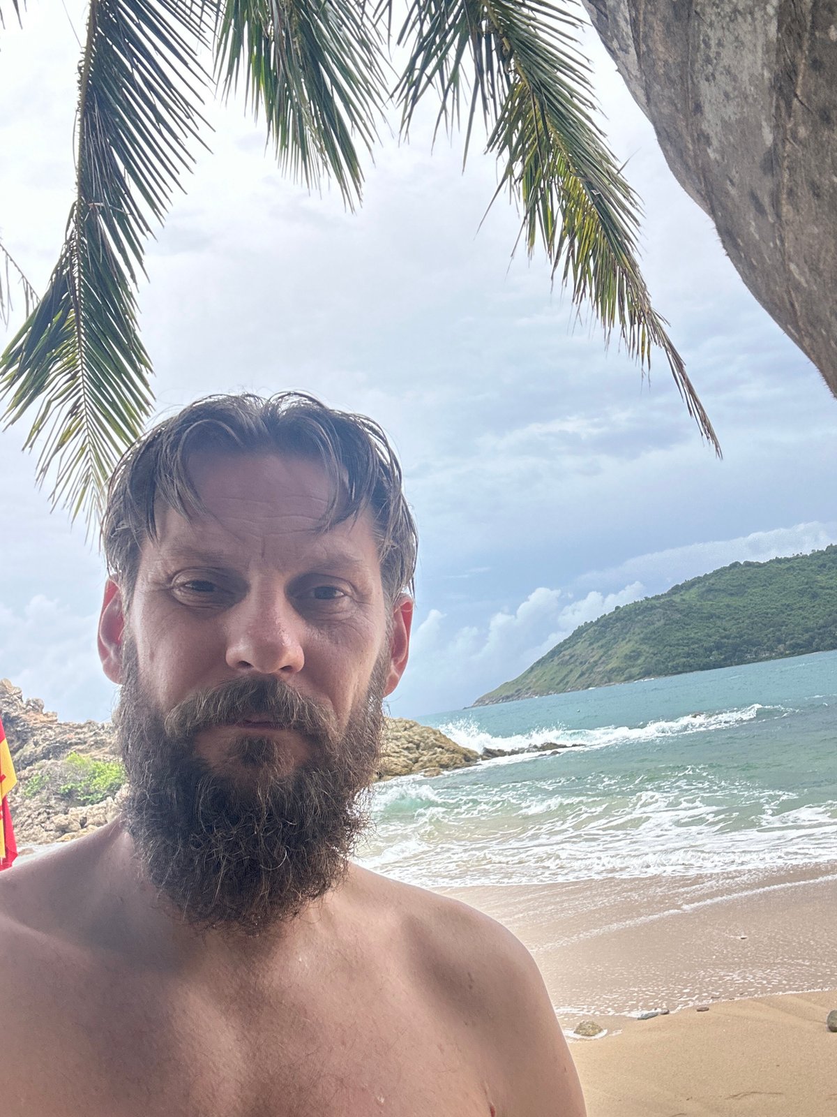 Rescue board on Rawai Beach, morning swim session underway