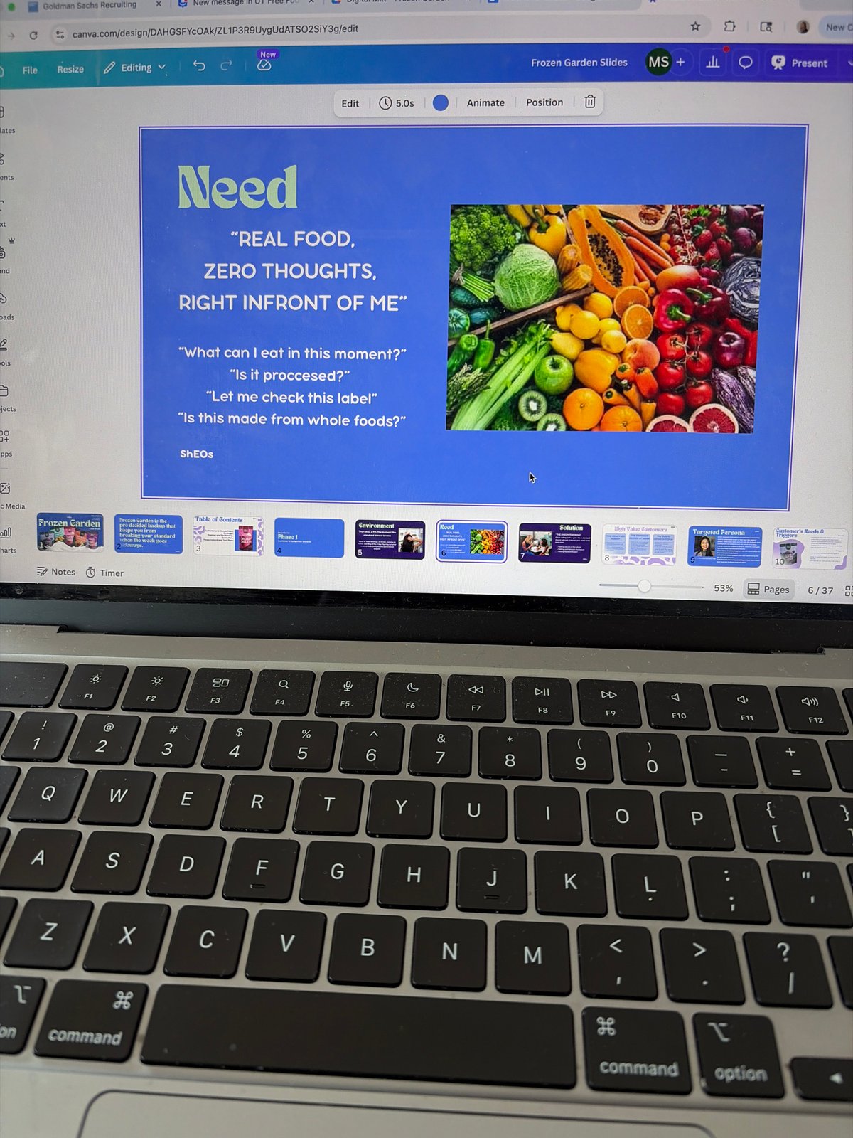 Person works on Canva presentation using MacBook in Austin workspace
