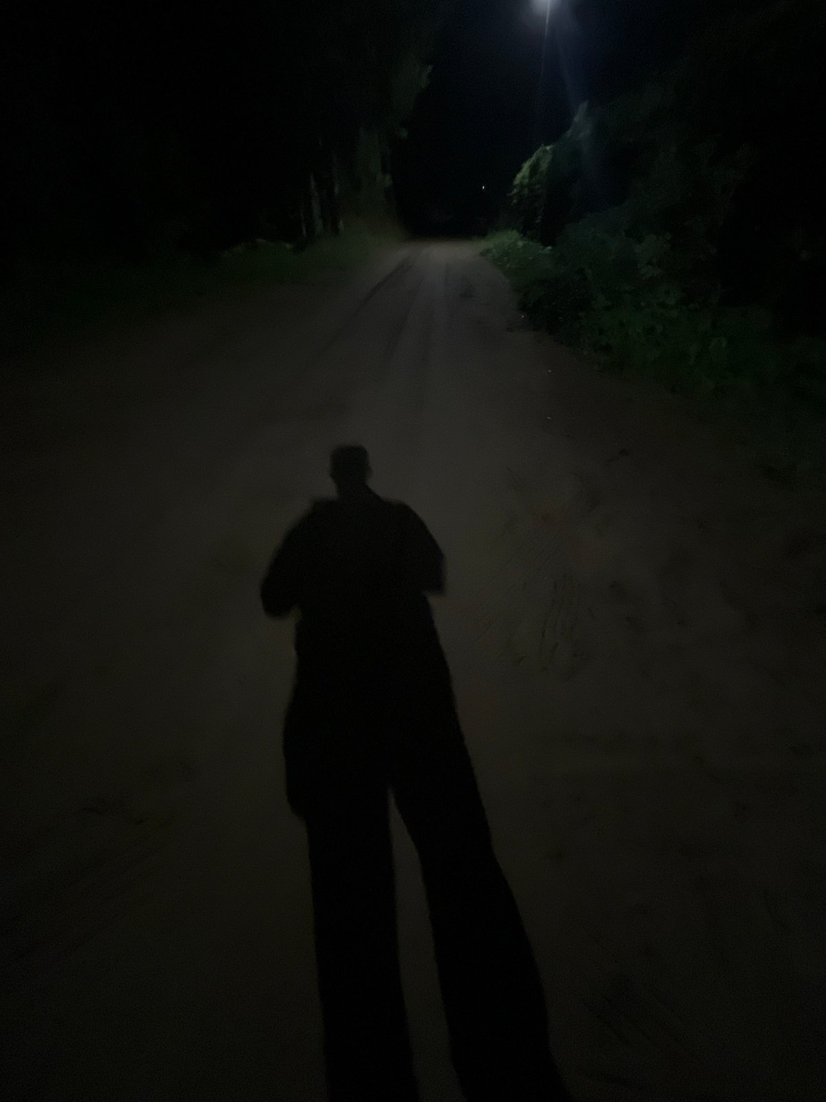 Human shadow captured on unpaved road in Chaikovsky