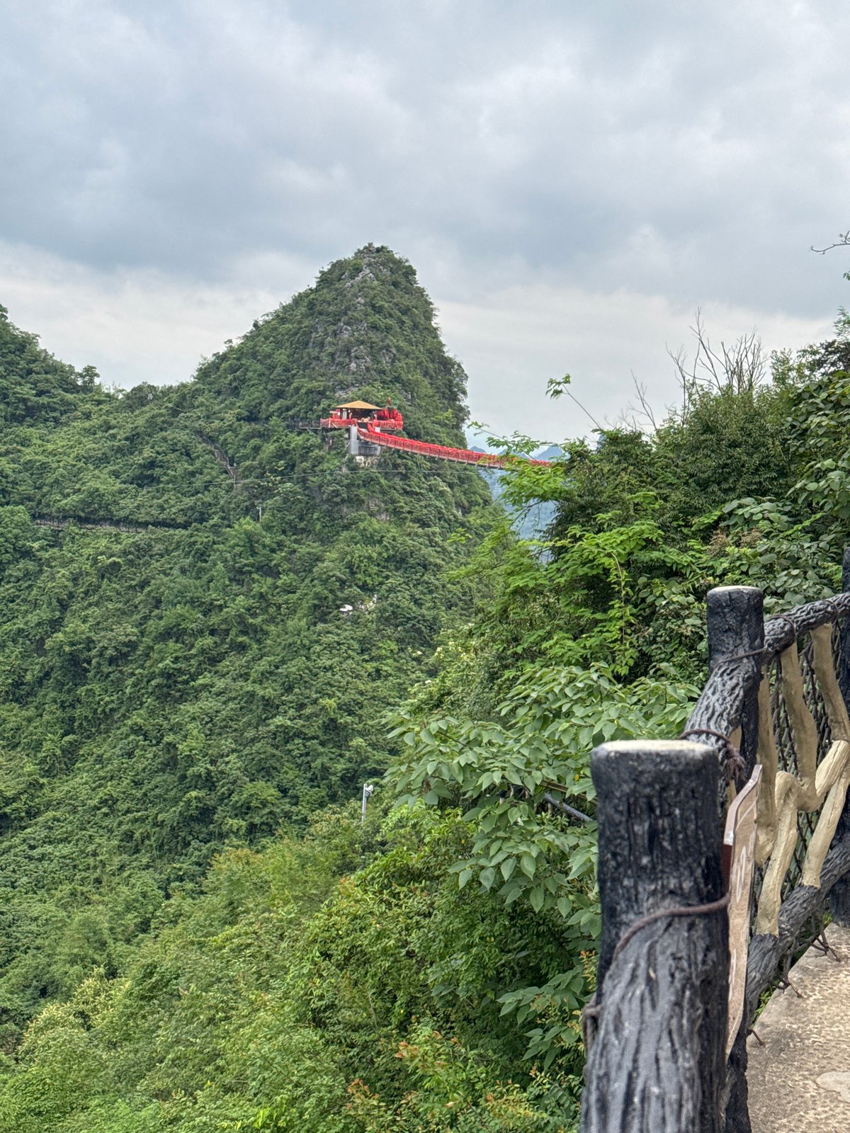 Elevated red walkway winds through Guilin's forested mountains