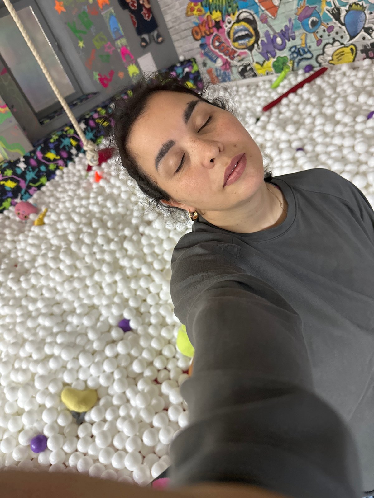 Hanging out in a colorful ball pit venue on a Friday afternoon