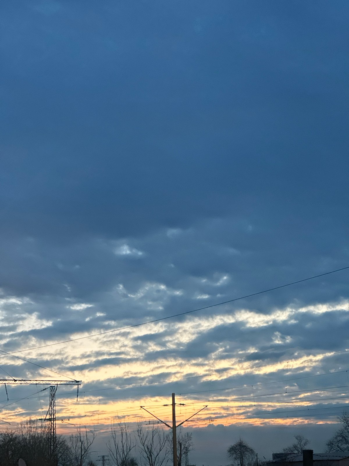 Horizontal cloud formations align with power lines in Bulgaria