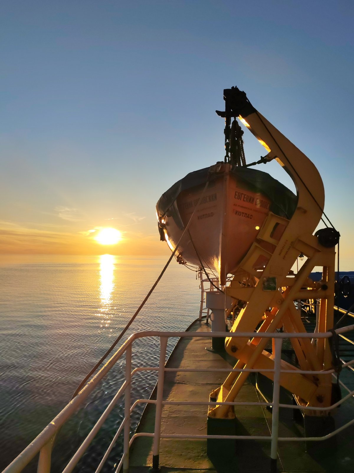 Maritime sunset documented by shipboard witnesses at sea