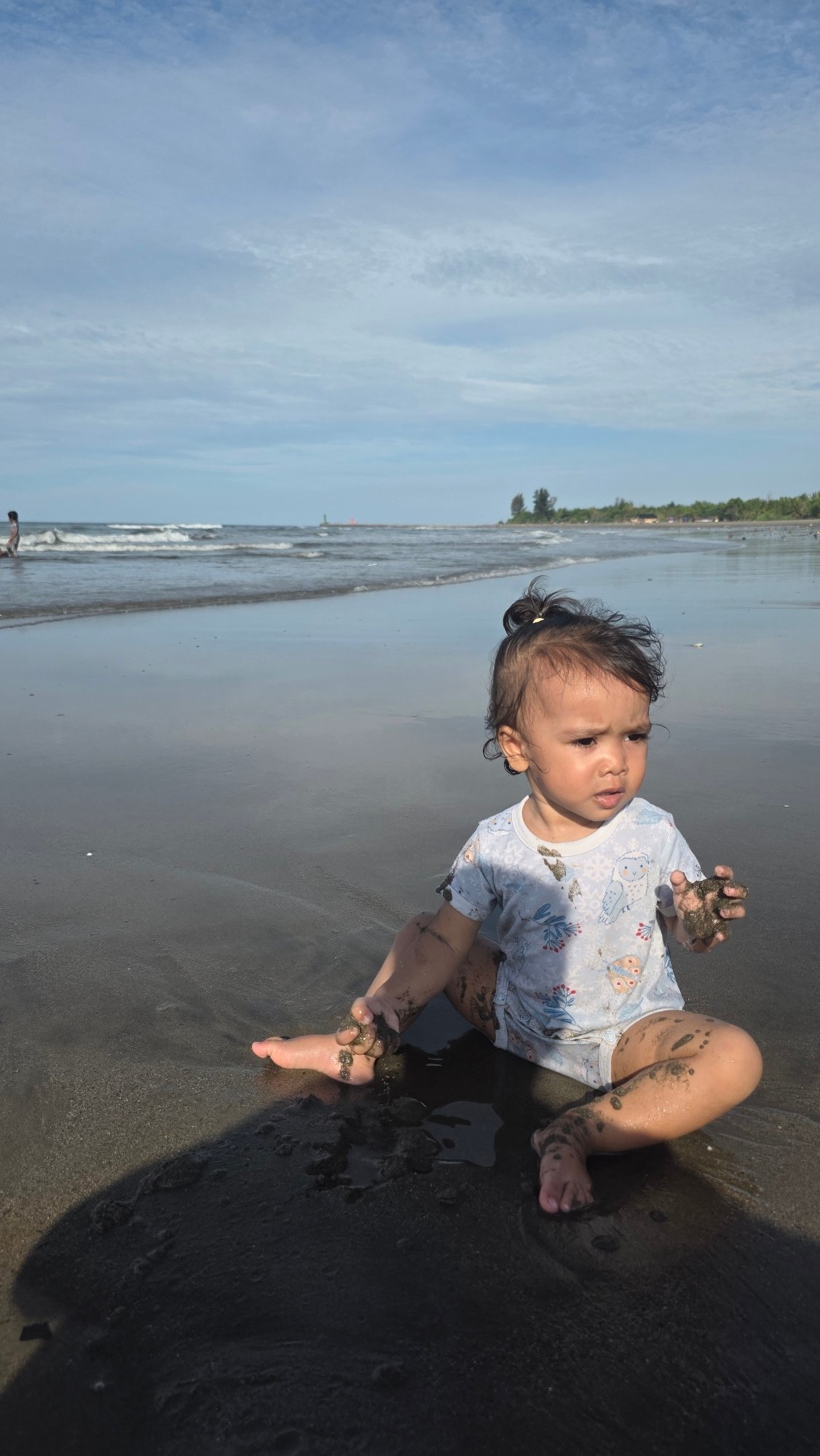 Child plays, crabs scuttle across Indonesian beaches Sunday morning