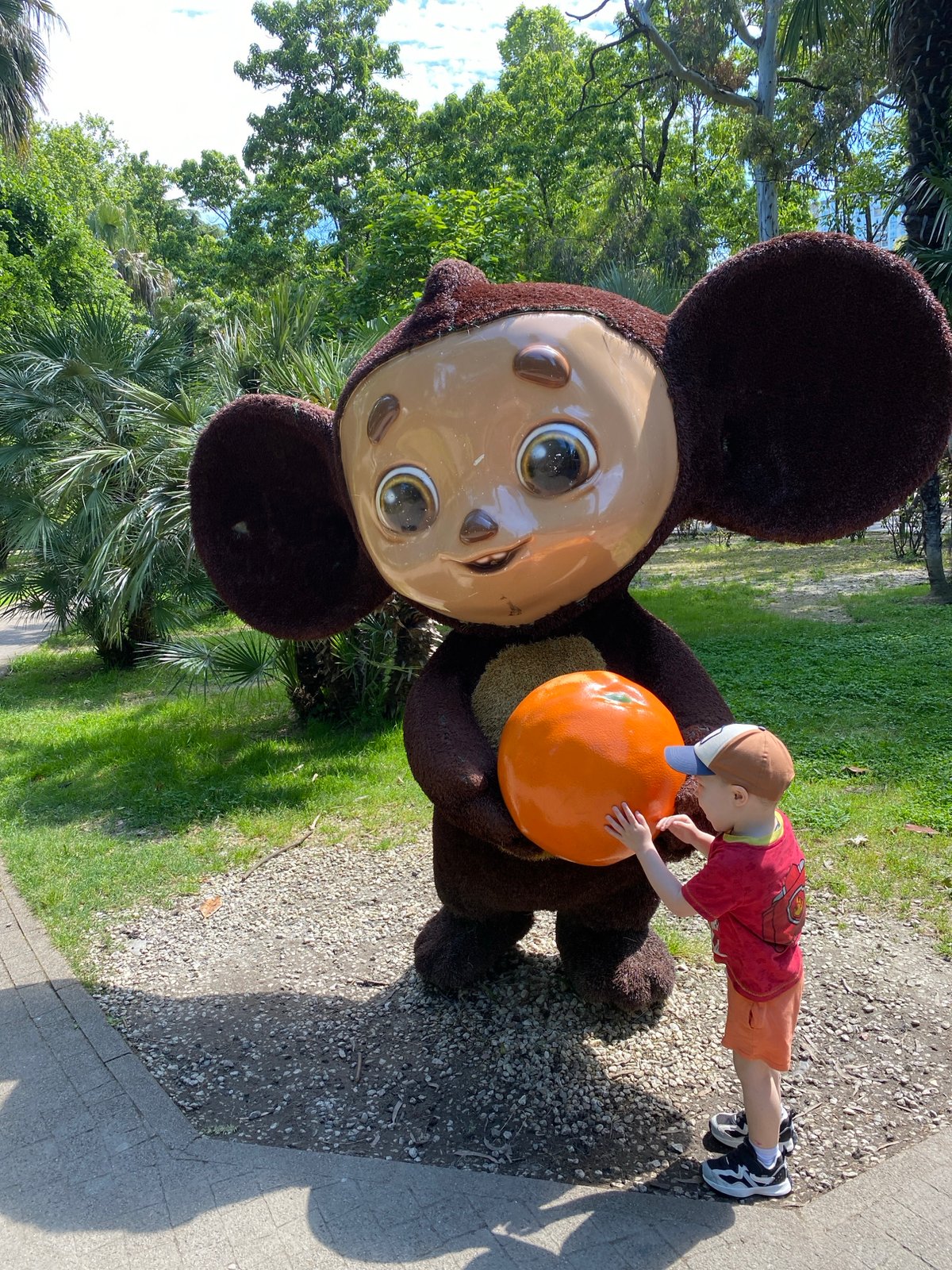 Child plays with Cheburashka statue in Sochi park