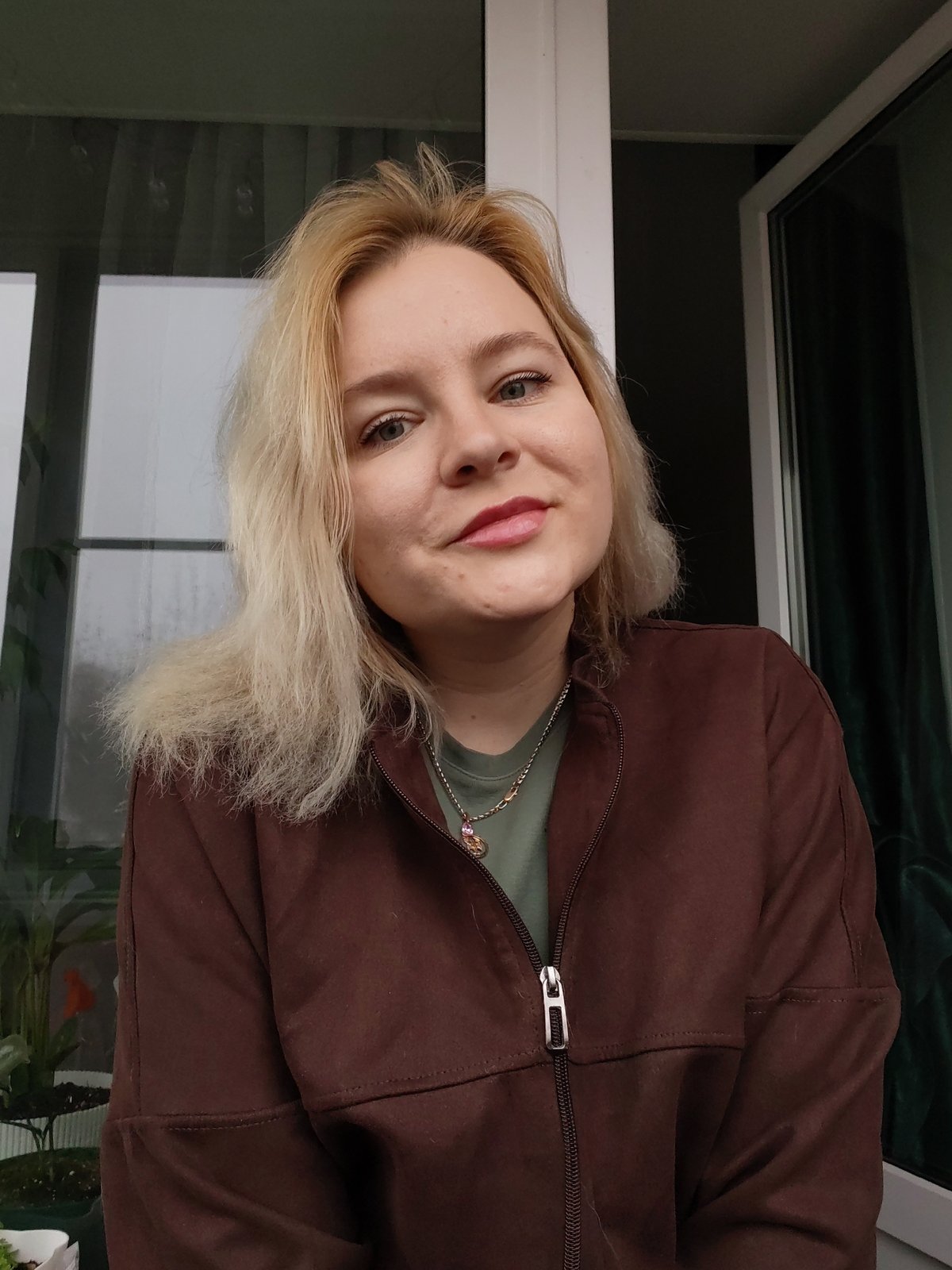 Woman observed indoors during rainy morning in Izhevsk