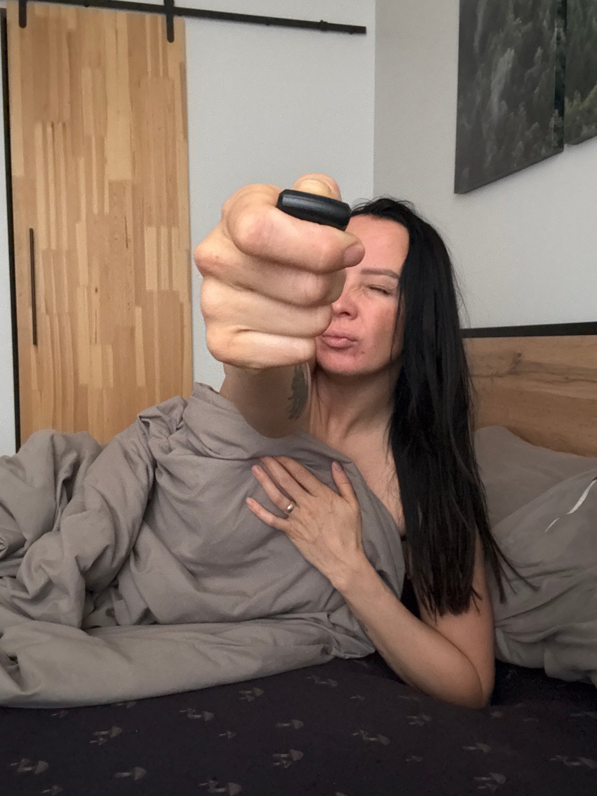 Woman photographed in bed during morning hours in Chaikovsky