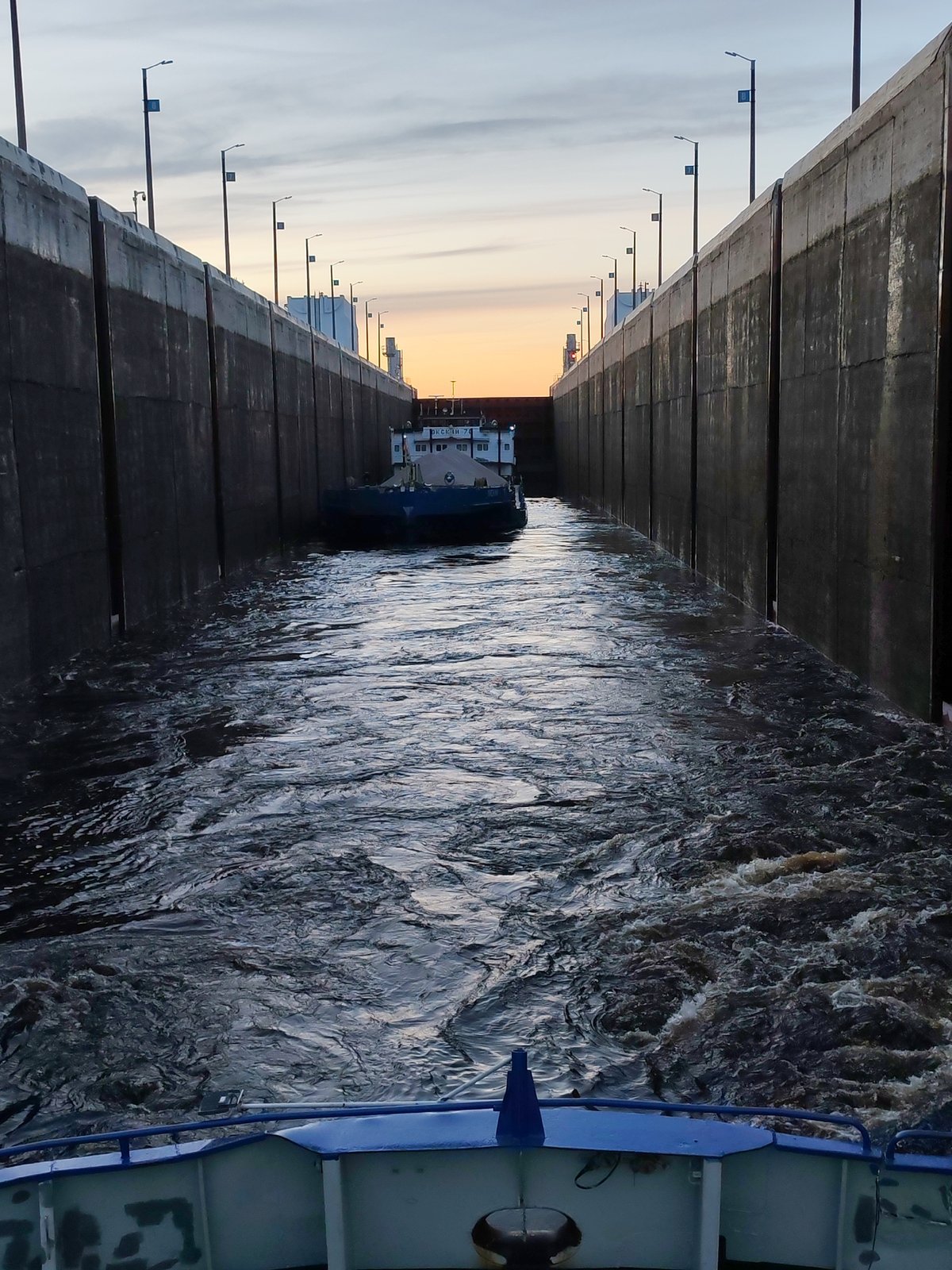 Cargo barges transit Volga-Baltic Waterway lock in Sheksna, Russia