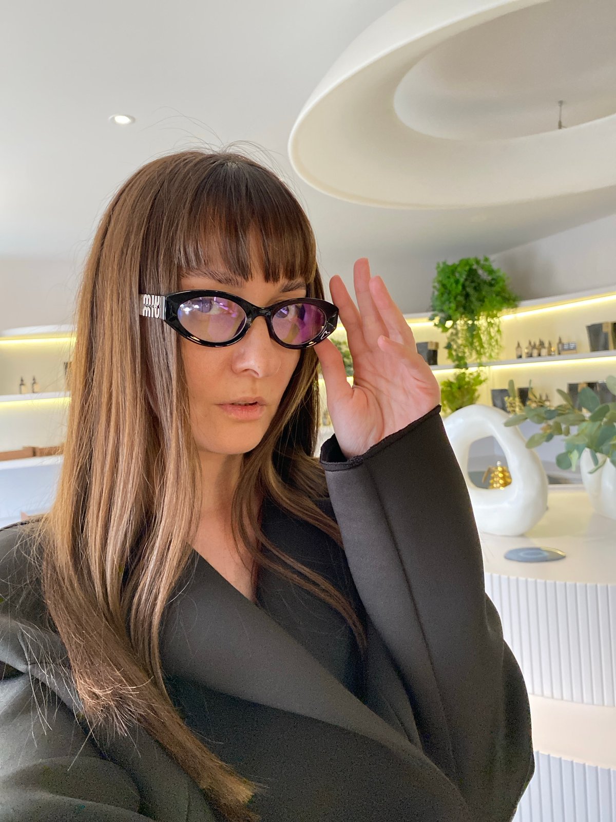 Woman shields eyes from light indoors in Votkinsk