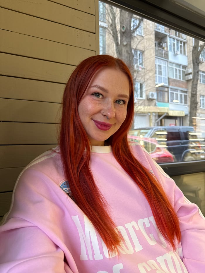 Red-haired woman documents afternoon cafe tour in Rostov-on-Don