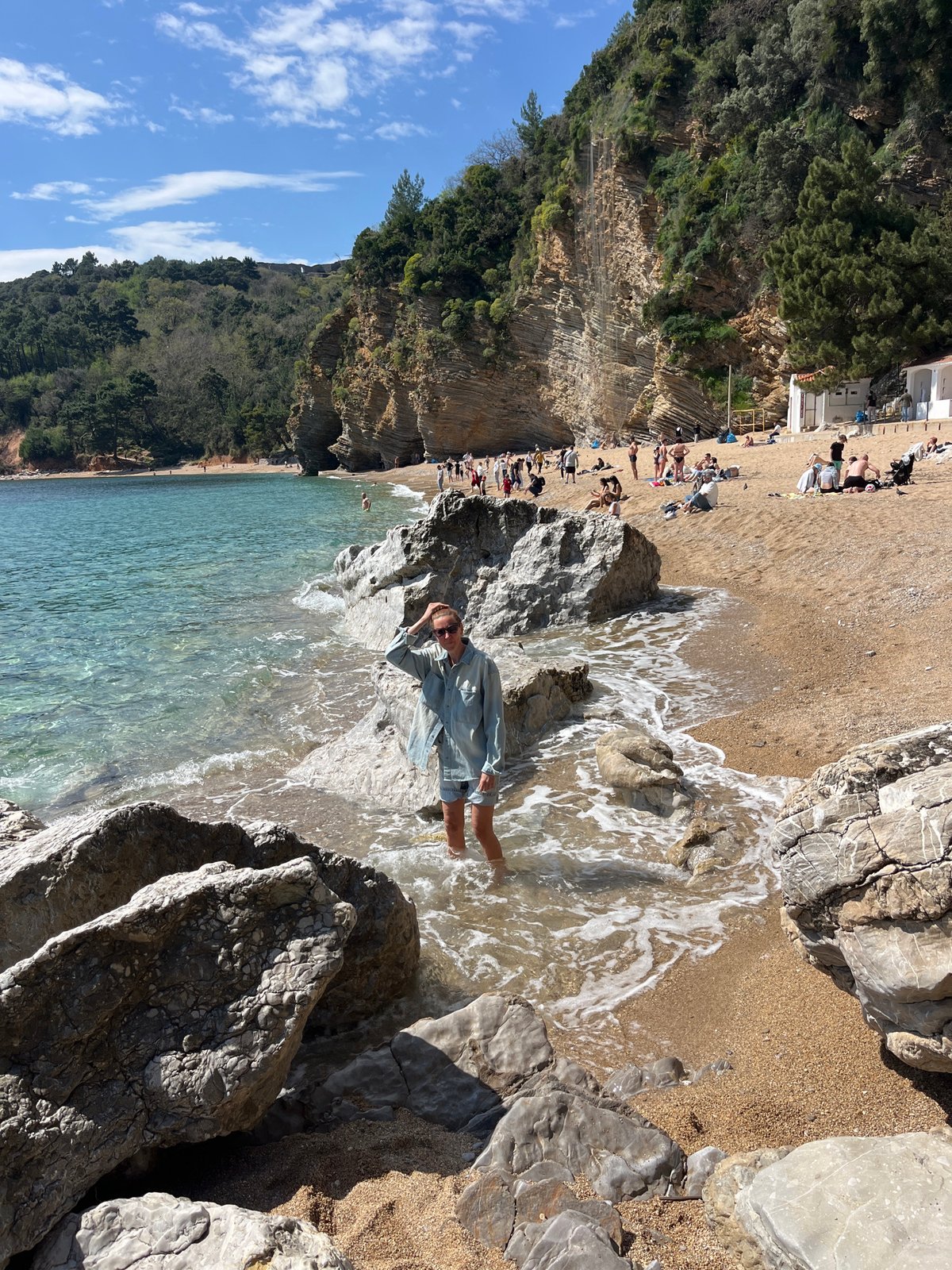 Woman relaxes in water at Pržno beach, Montenegro