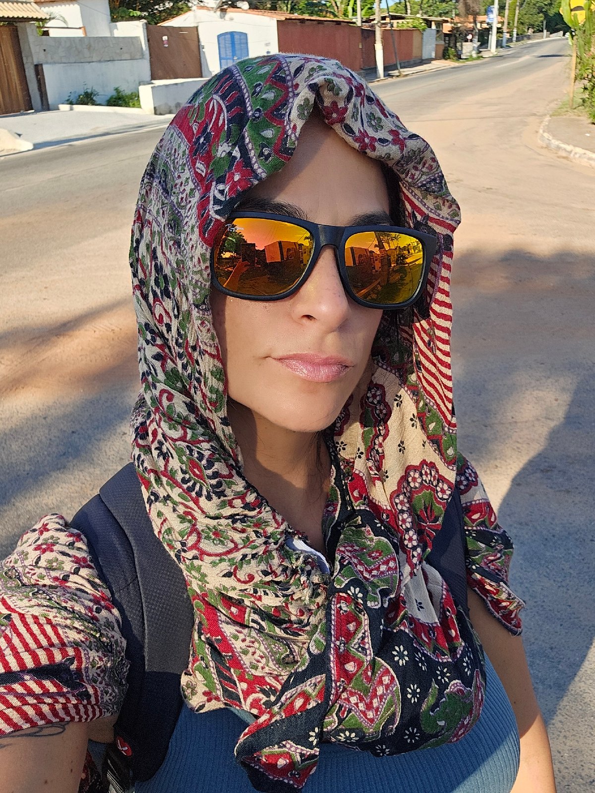 Person in orange sunglasses photographed in Búzios, Brazil
