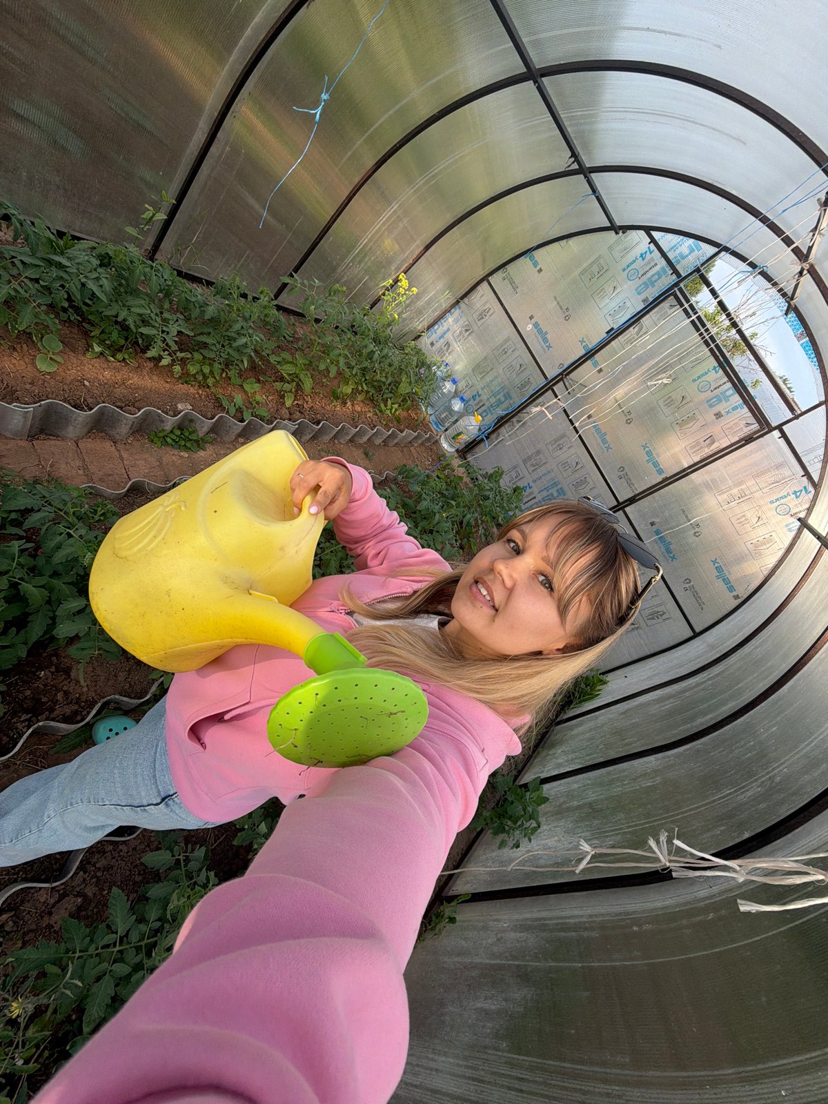 Woman documents greenhouse gardening session with pets in rural Russia