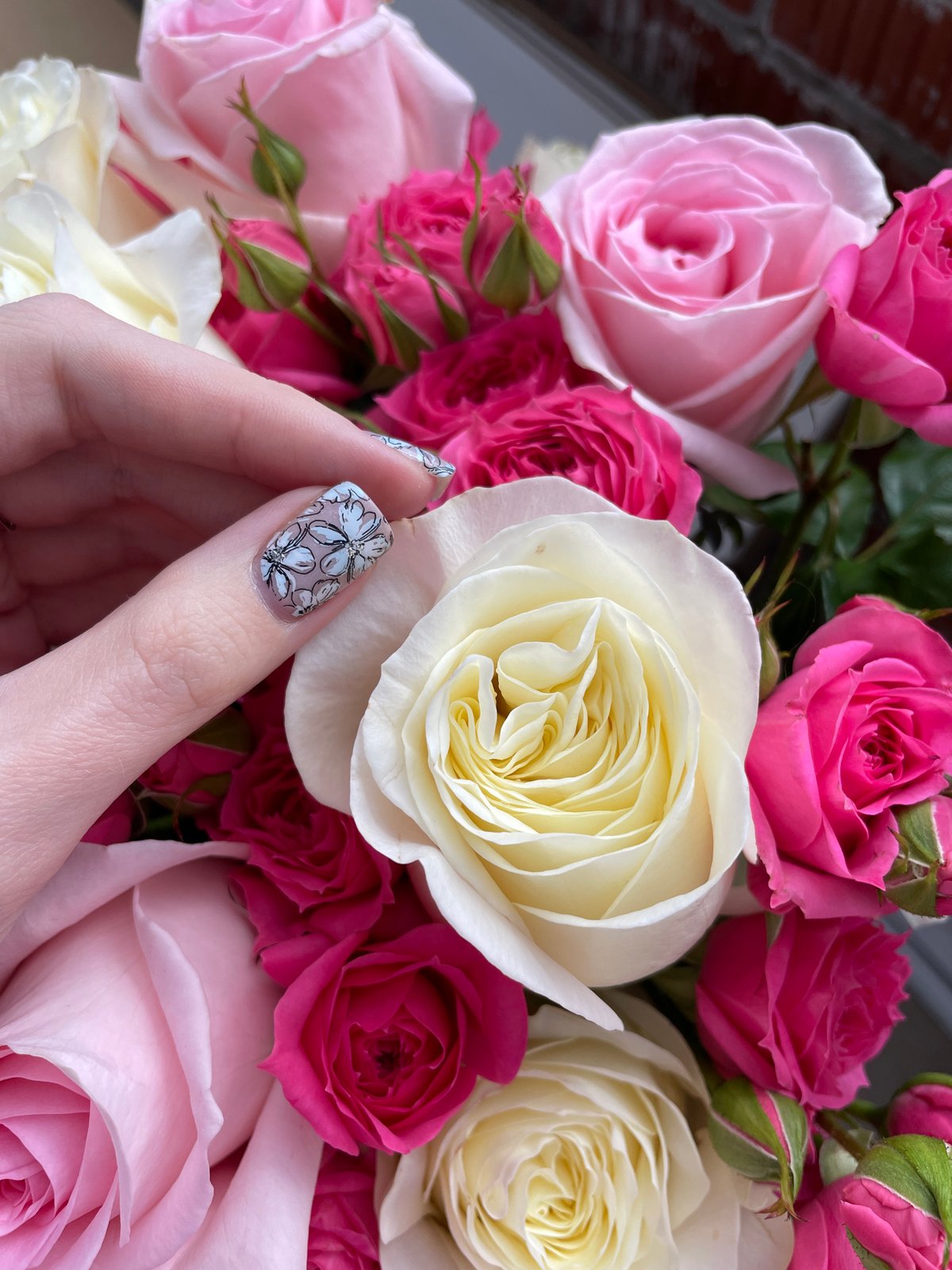 Person rests peacefully with rose bouquet in Izhevsk