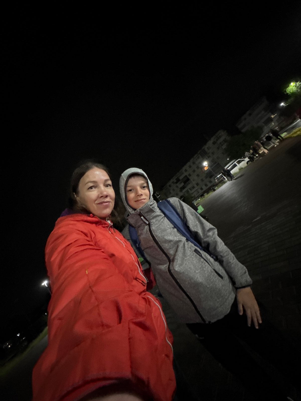 Woman and boy take nighttime selfie in Chaikovsky, Russia