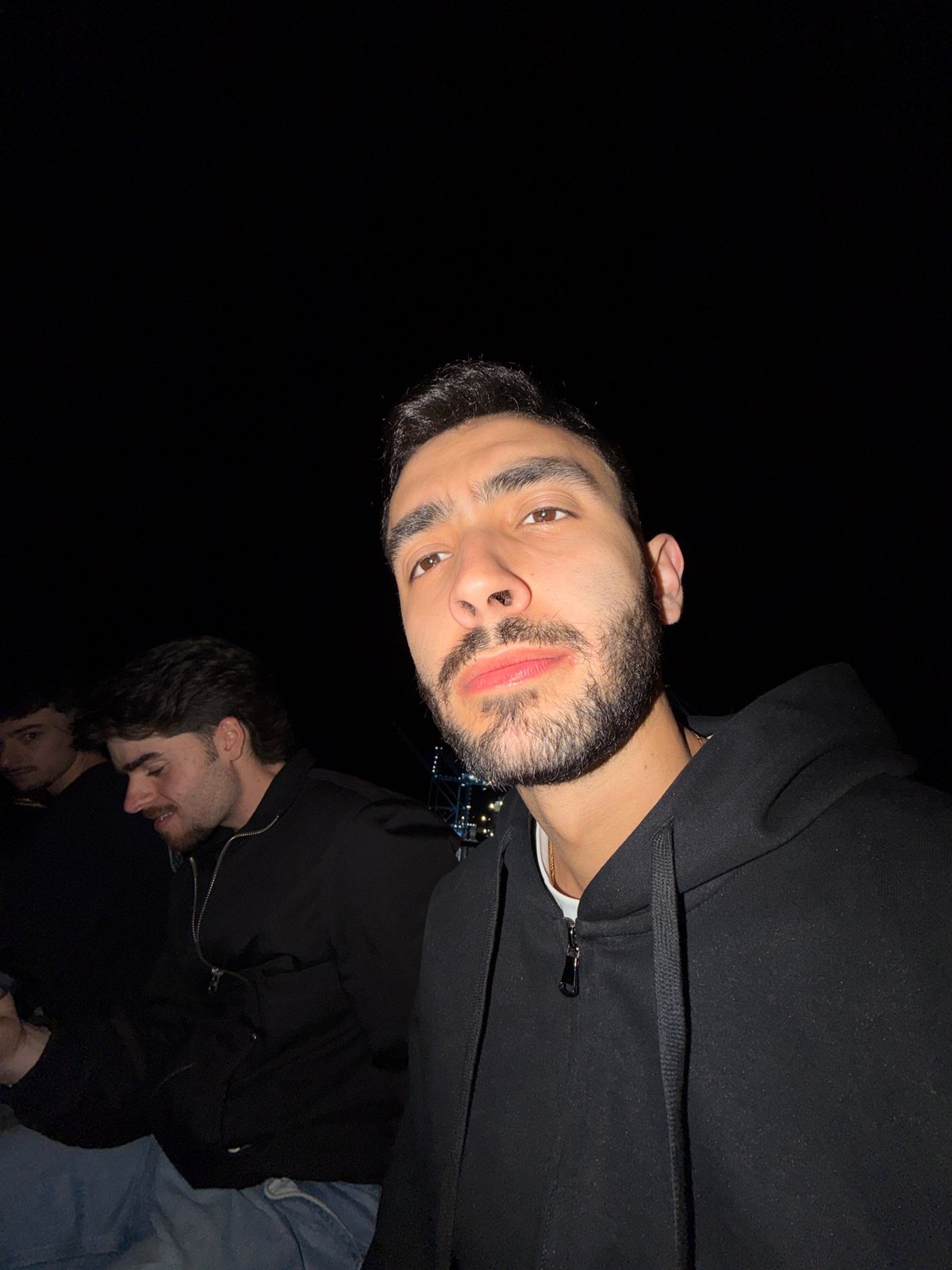 Three friends photograph together during night out in Rijeka