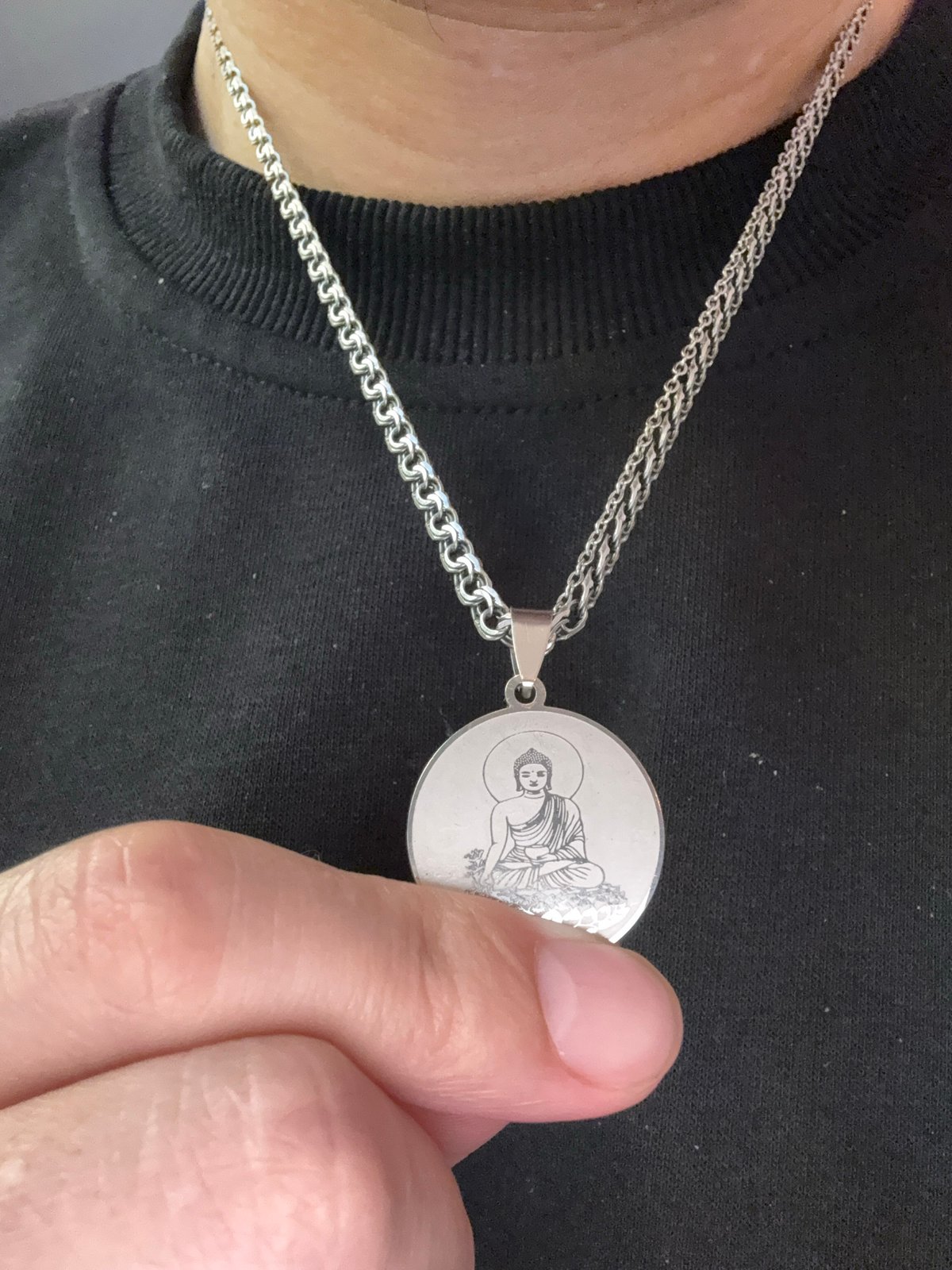 Silver Buddha pendant necklace, close up in Moscow