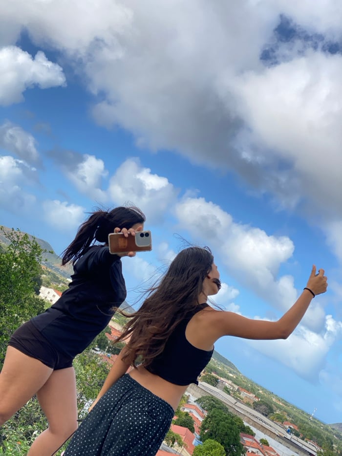 Tourists photograph scenic views, cattle in Venezuelan mountain towns