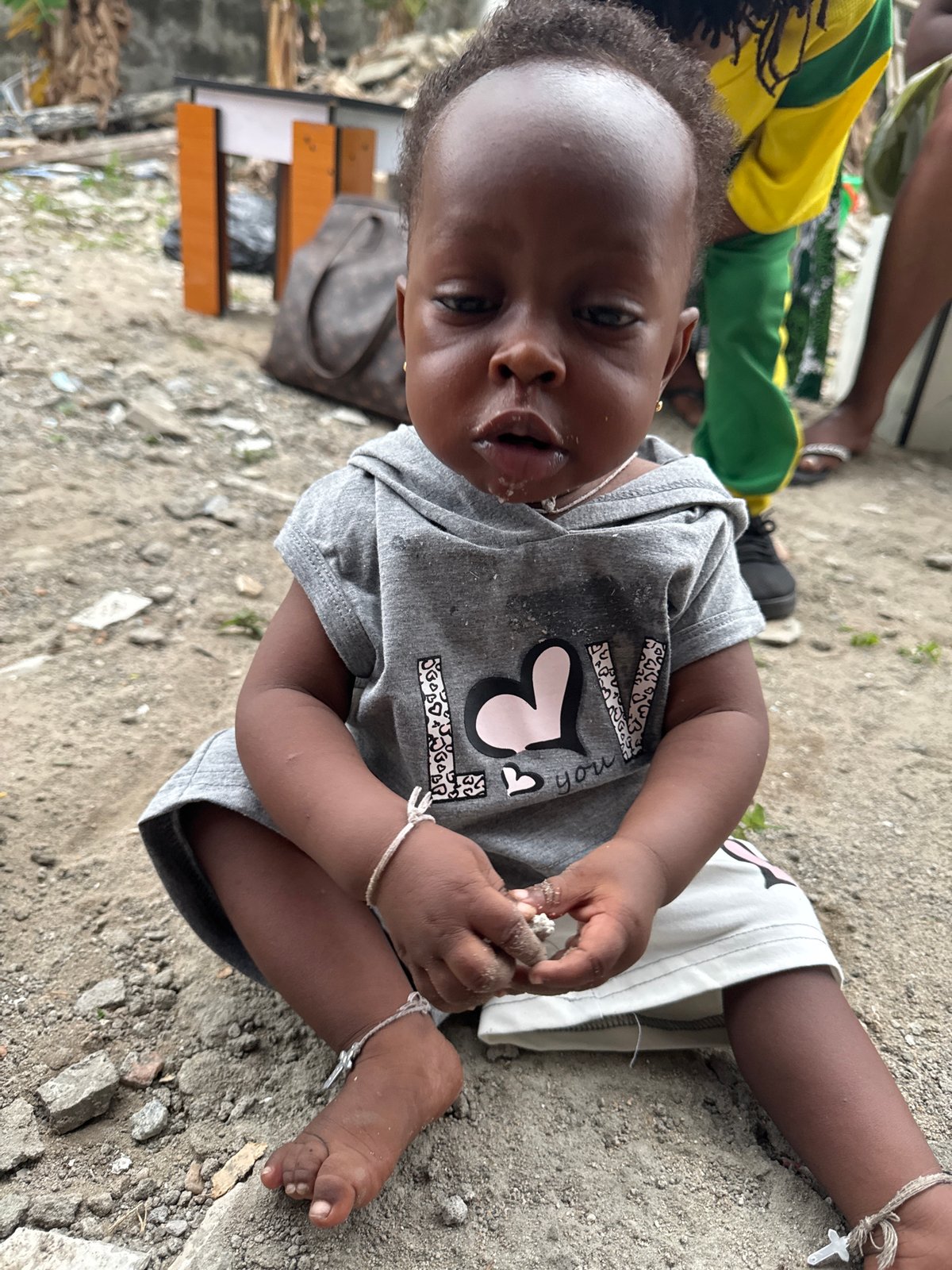 Toddler in "LOVE you" shirt photographed in Ajara, Nigeria