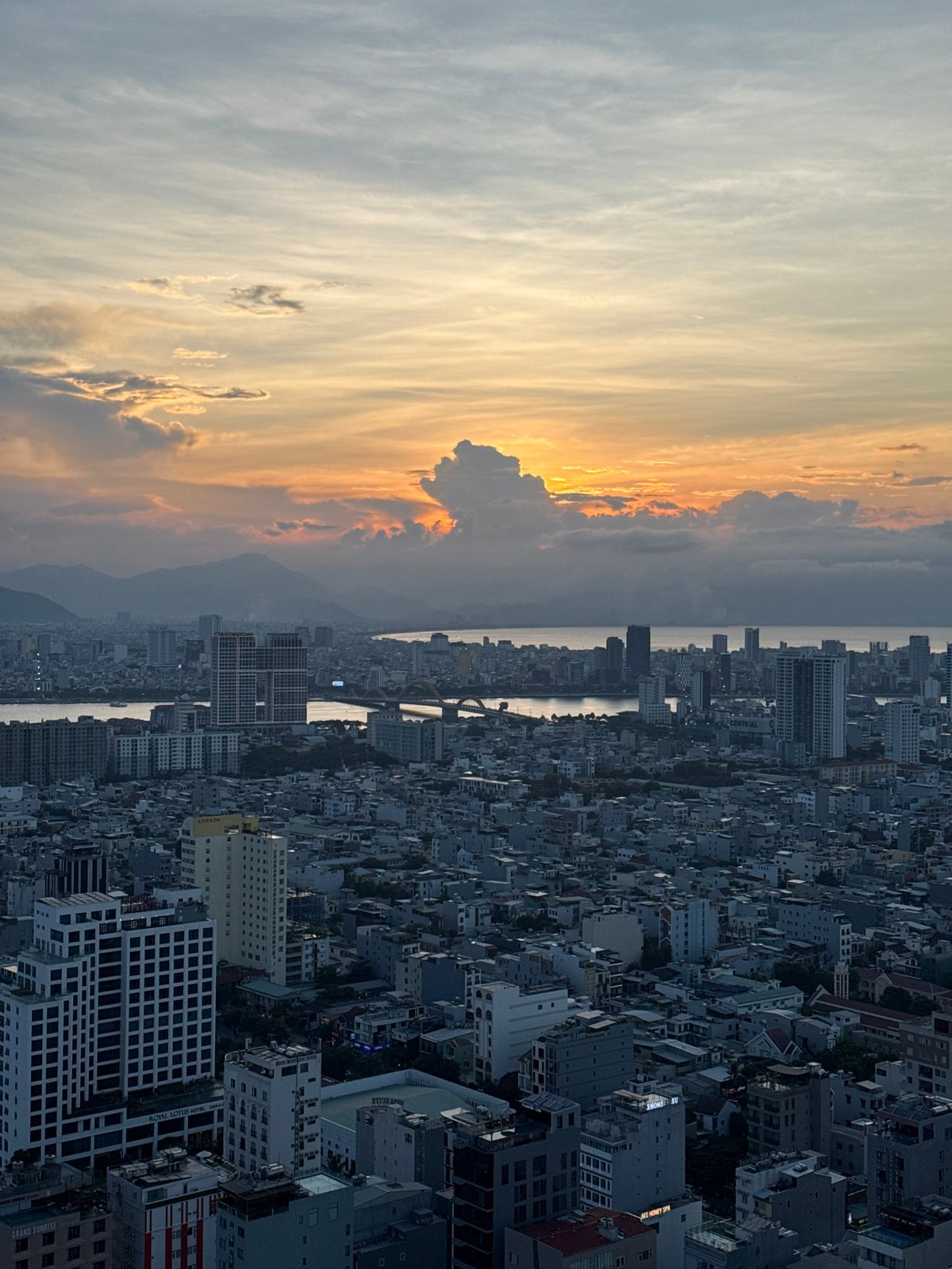Da Nang at sunset: crowded beaches and city skyline from above