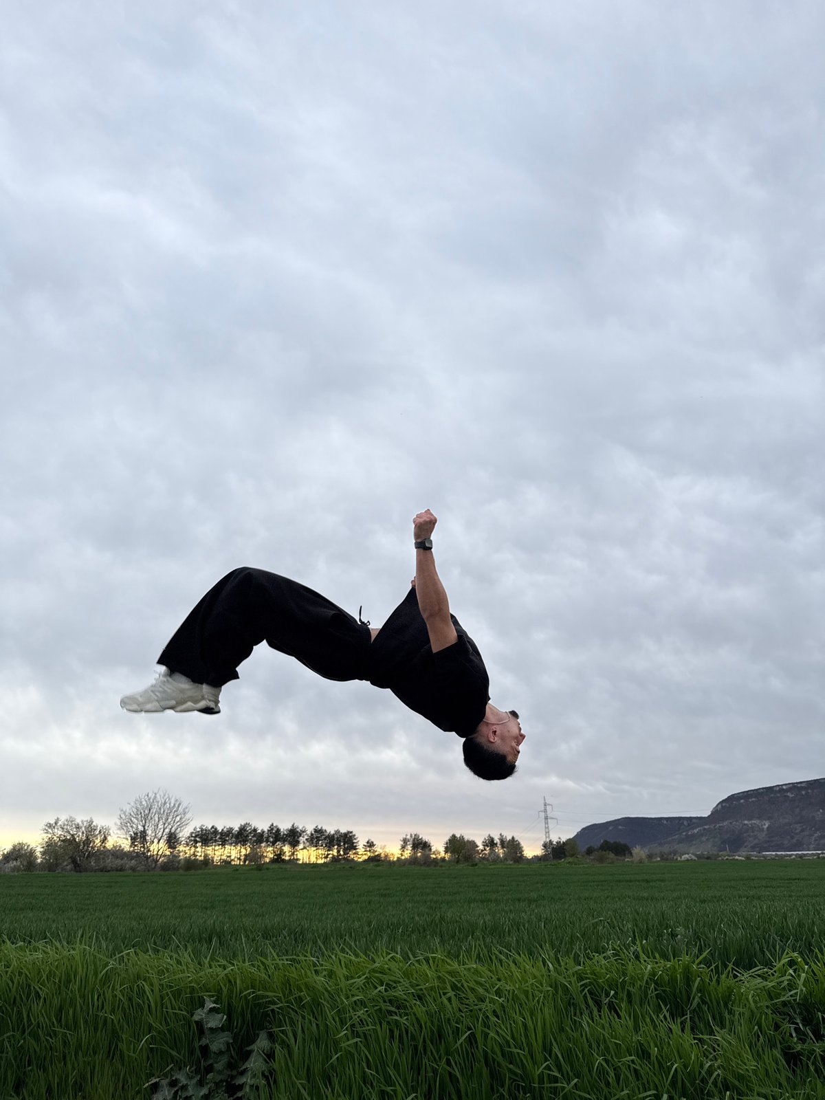 Man performs backflips in field near Shumen, Bulgaria