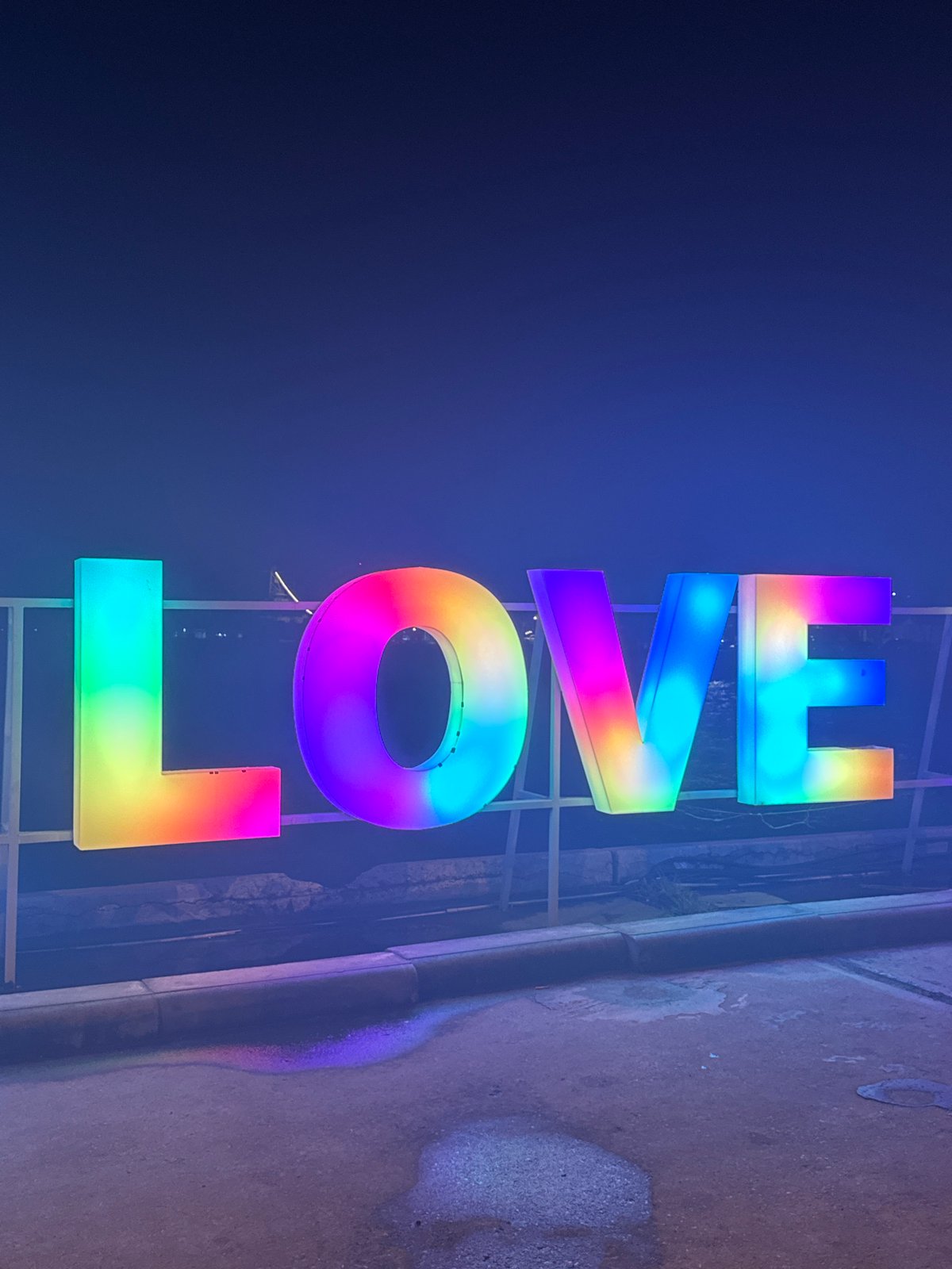 Rainbow LED love signs illuminate Koh Phangan Thailand night