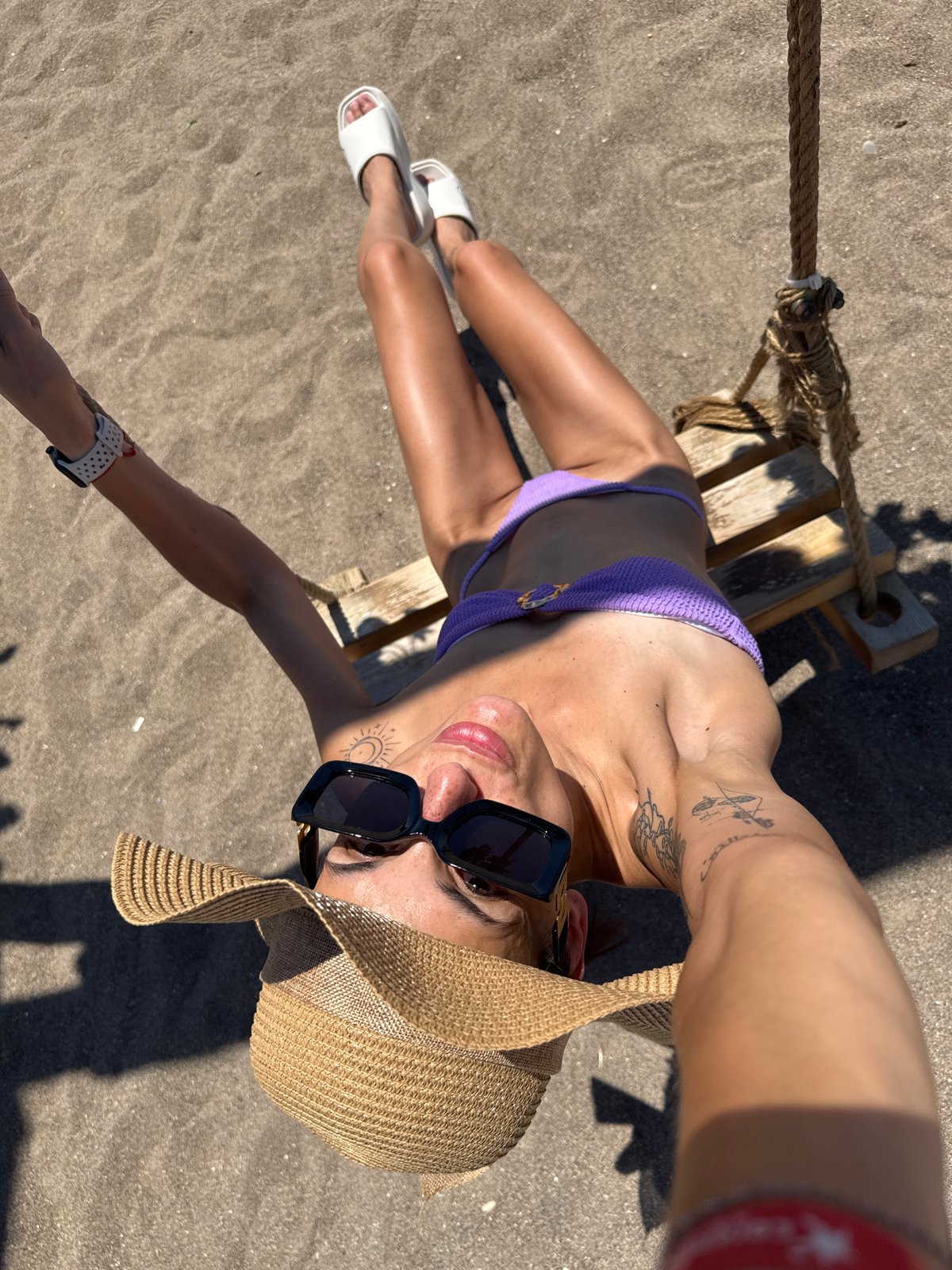 Lazy beach morning in Antalya, purple bikini and straw hat.