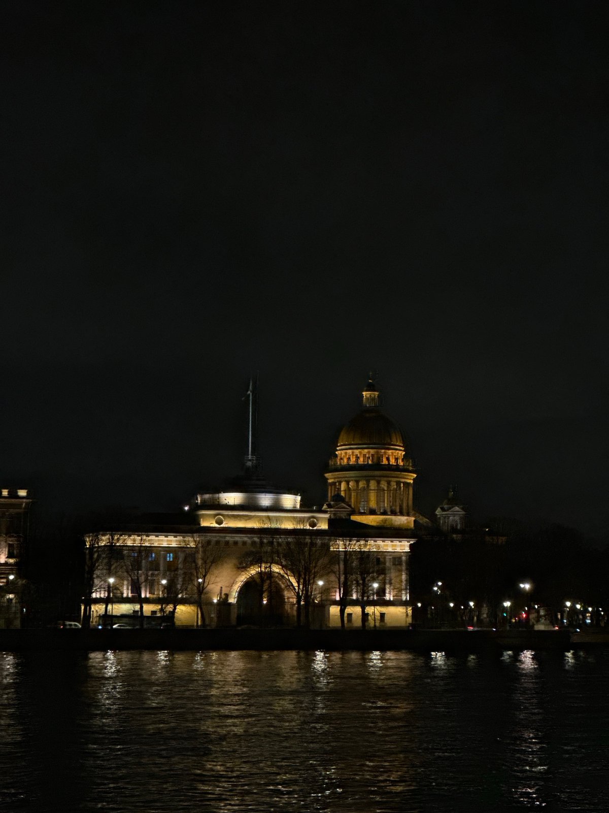St. Isaac's Cathedral illuminated at night, reflected in waters