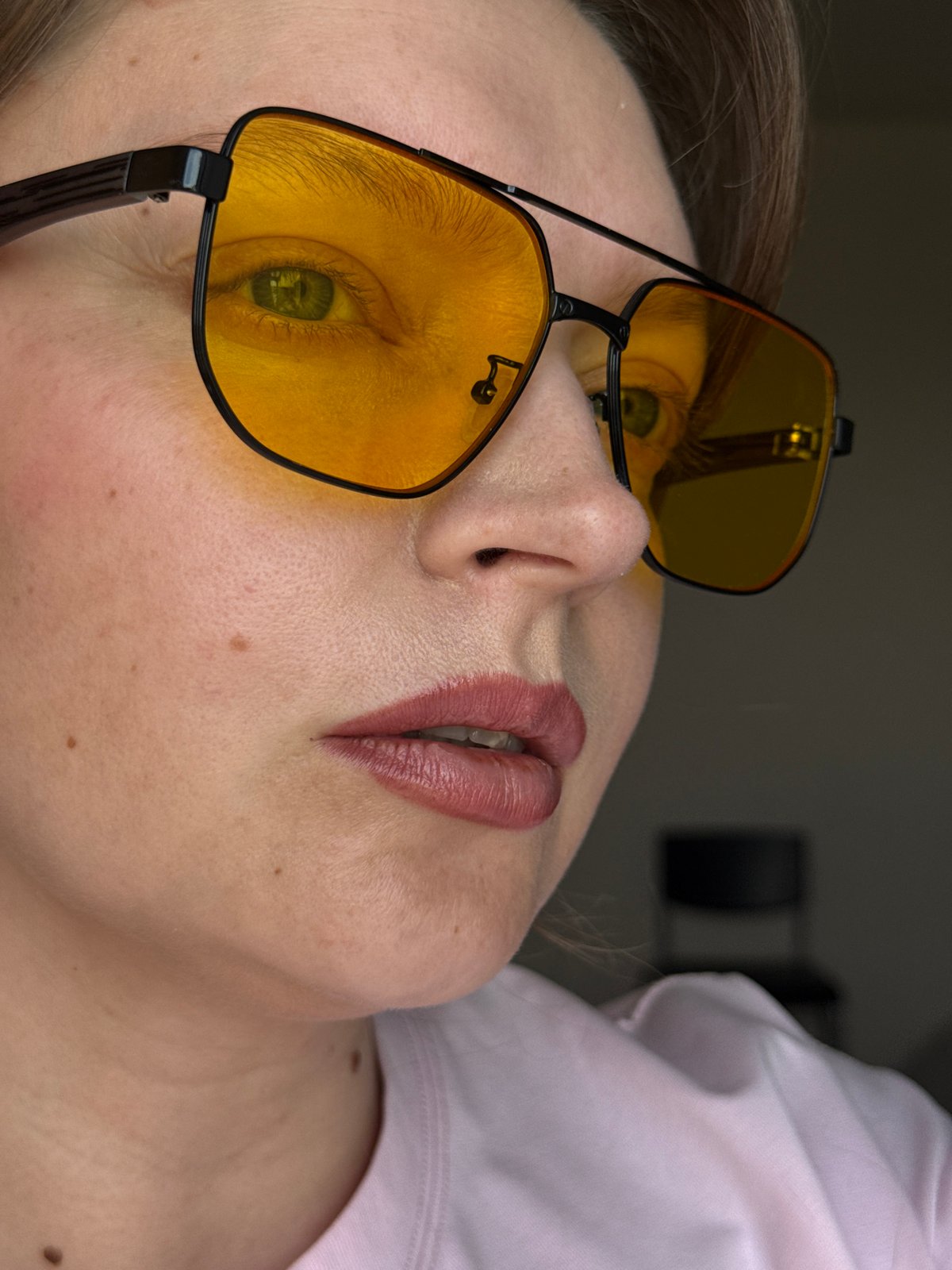Woman documents eyewear styling session in Izhevsk apartment