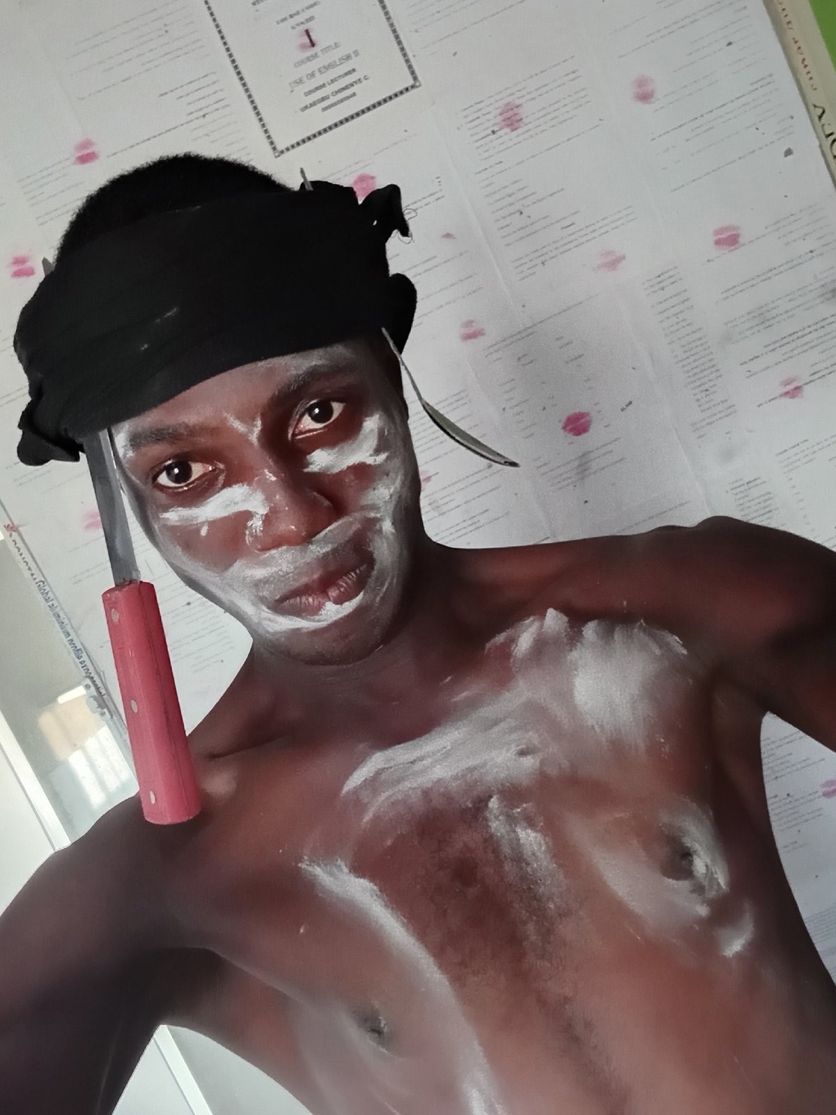 Man in black head wrap performs with kitchen utensils