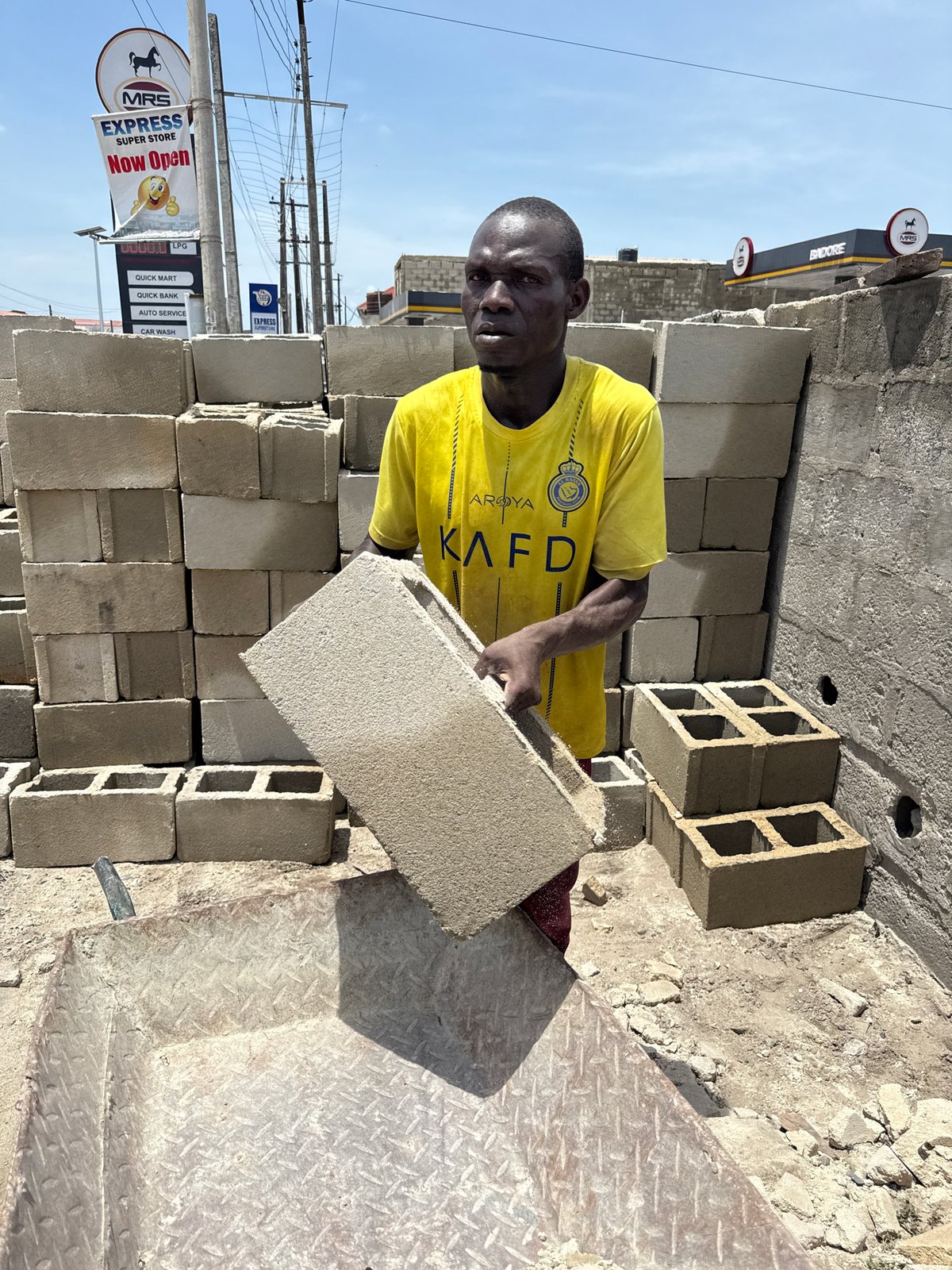 Workers clear demolition debris in Ado, Nigeria