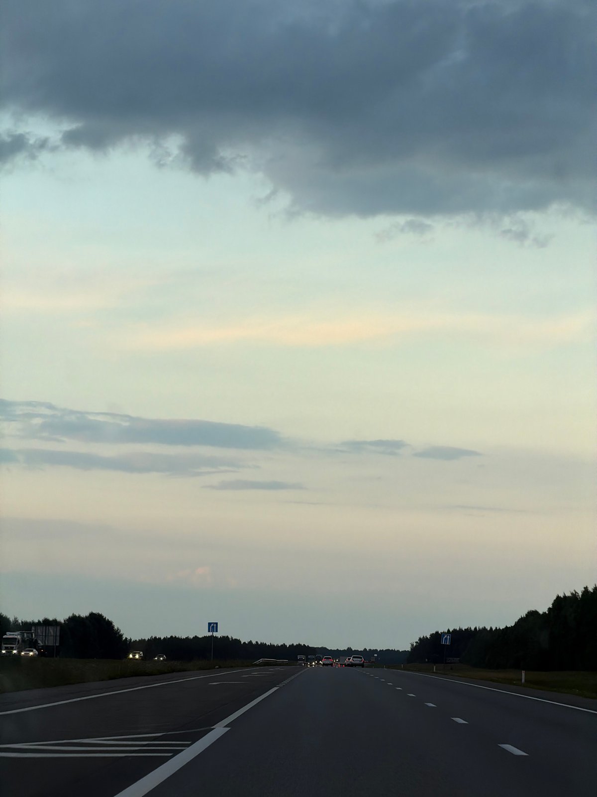 Evening highway drive through rural Russia under heavy clouds