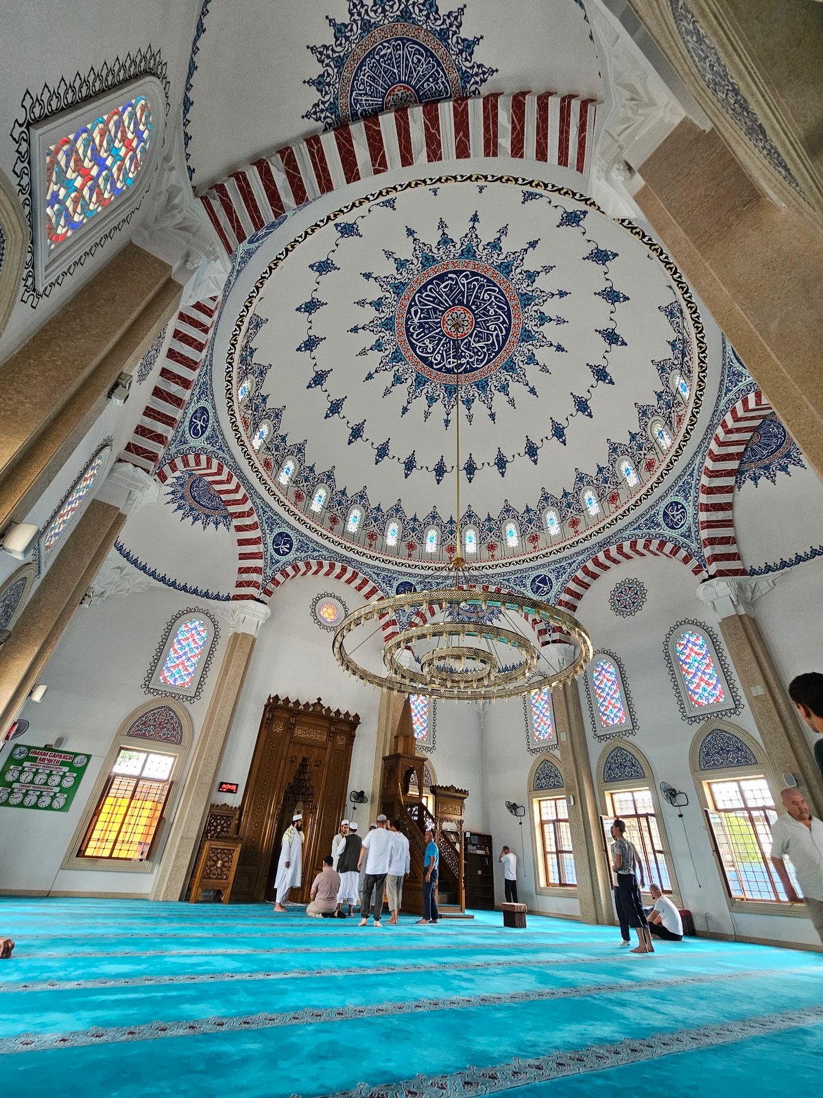Inside an Özgön mosque: dome details and congregation in prayer