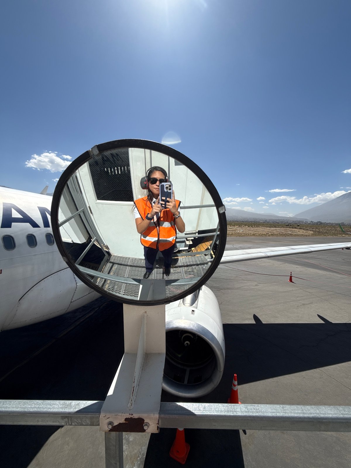 Passenger captures mirror selfie during flight over Peru mountains