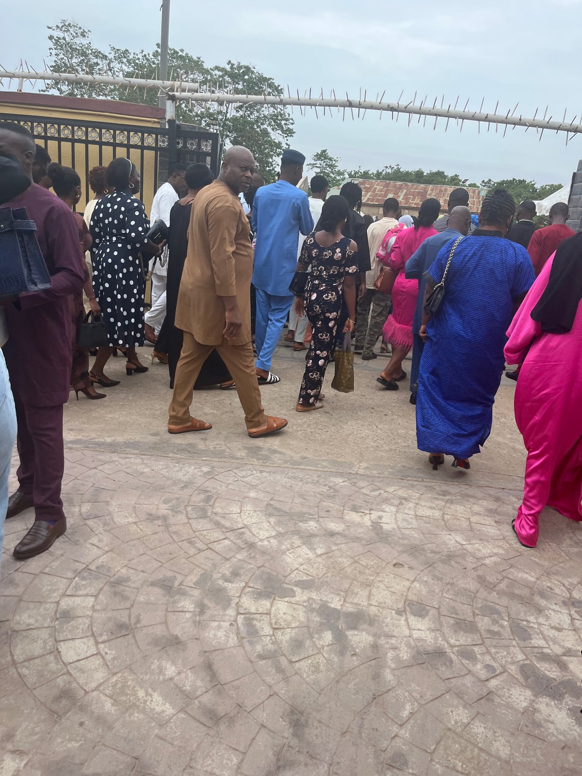 Public gathering documented in Abuja with diverse attendees queuing