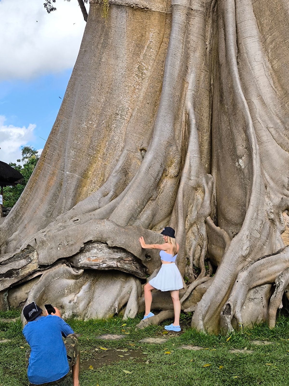 Young women pose at giant tree tourist spot in Indonesia